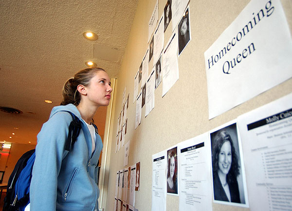 Student looks over homecoming candidates before voting