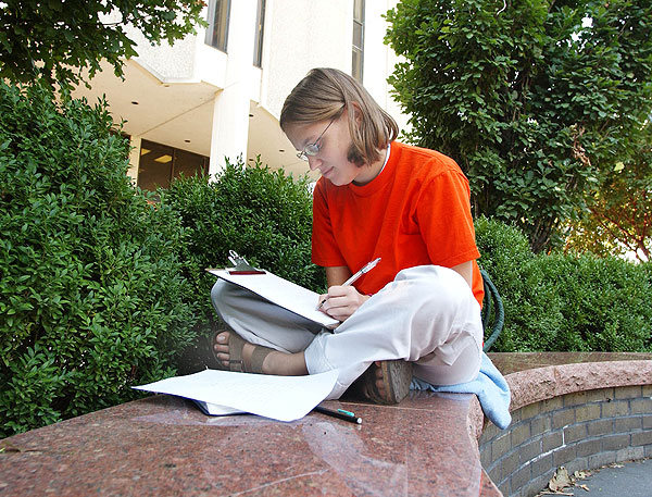 Student studies in front of Allen Hall