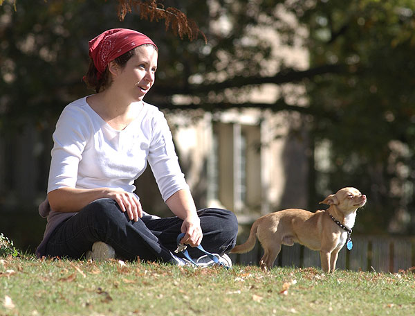 Girl and dog enjoying playing in sunshine