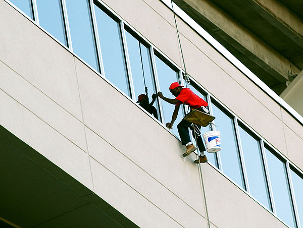 Washing windows at football stadium