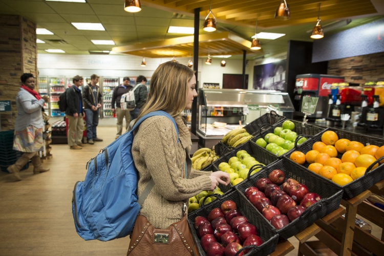 Student buying fruit in the Union P.O.D. store