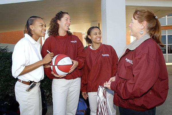 Women&amp;#039;s basketball players signing ball before departure