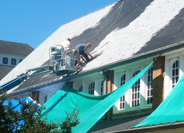 Roofers work atop Perry Cafeteria