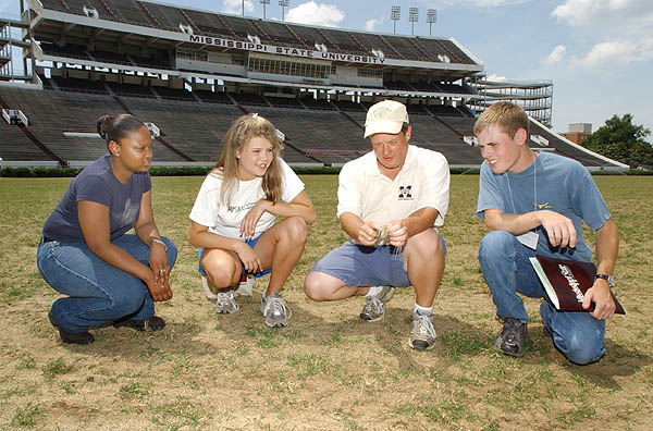 Horticulture campers look at football turf