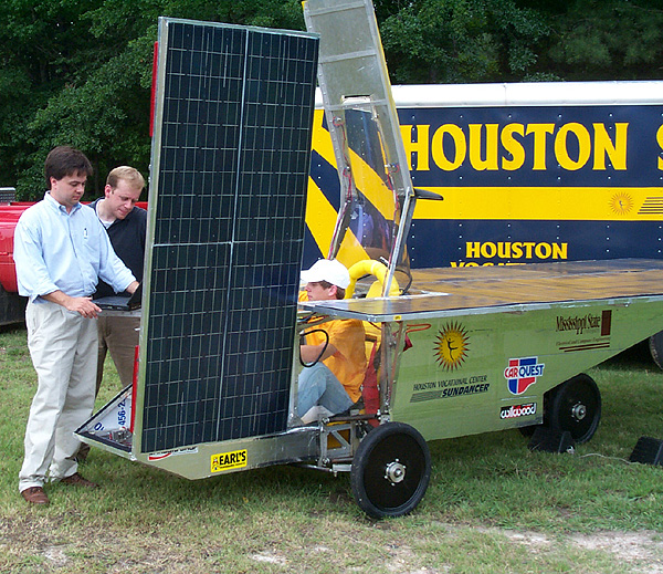 Engineering students work with solar car