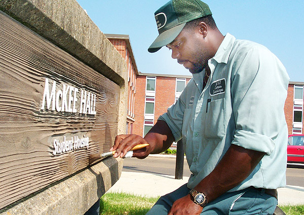 Campus Landscape paints McKee Hall sign