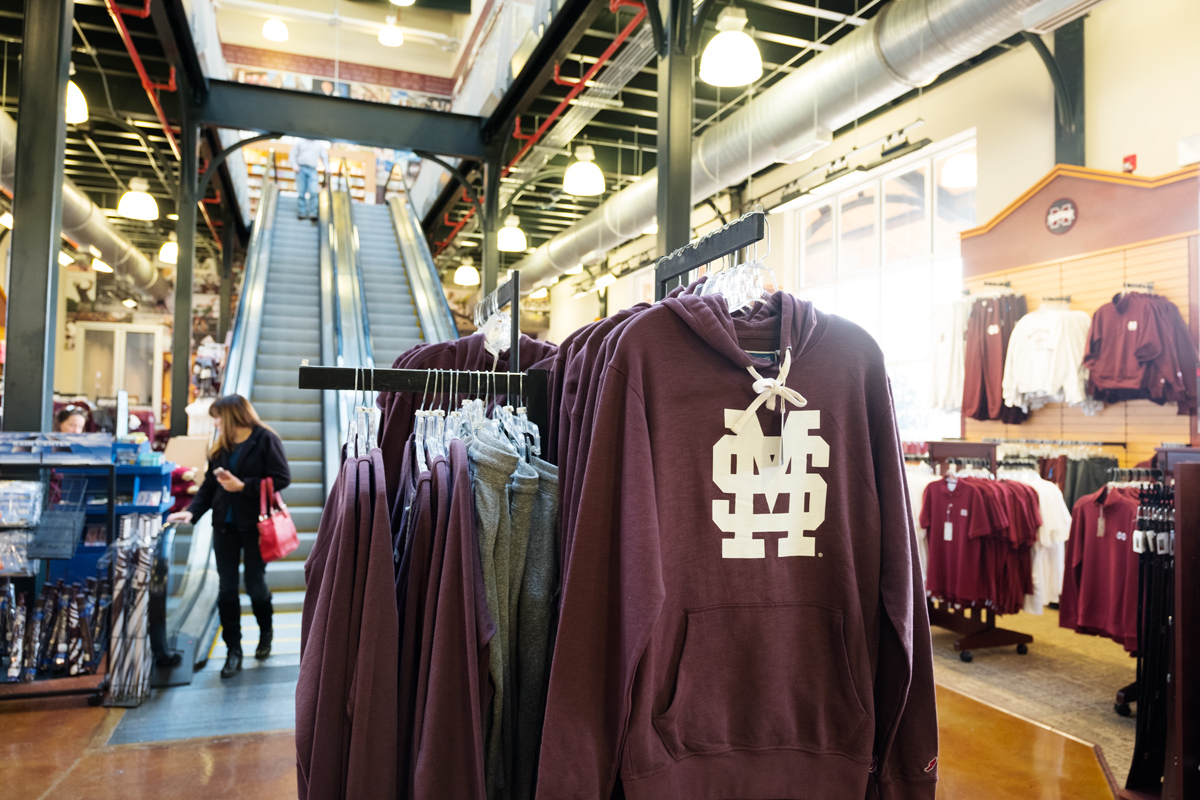 With MSU merchandise in the foreground, Barnes &amp;amp;amp; Noble holiday shoppers descend the escalators in the background.