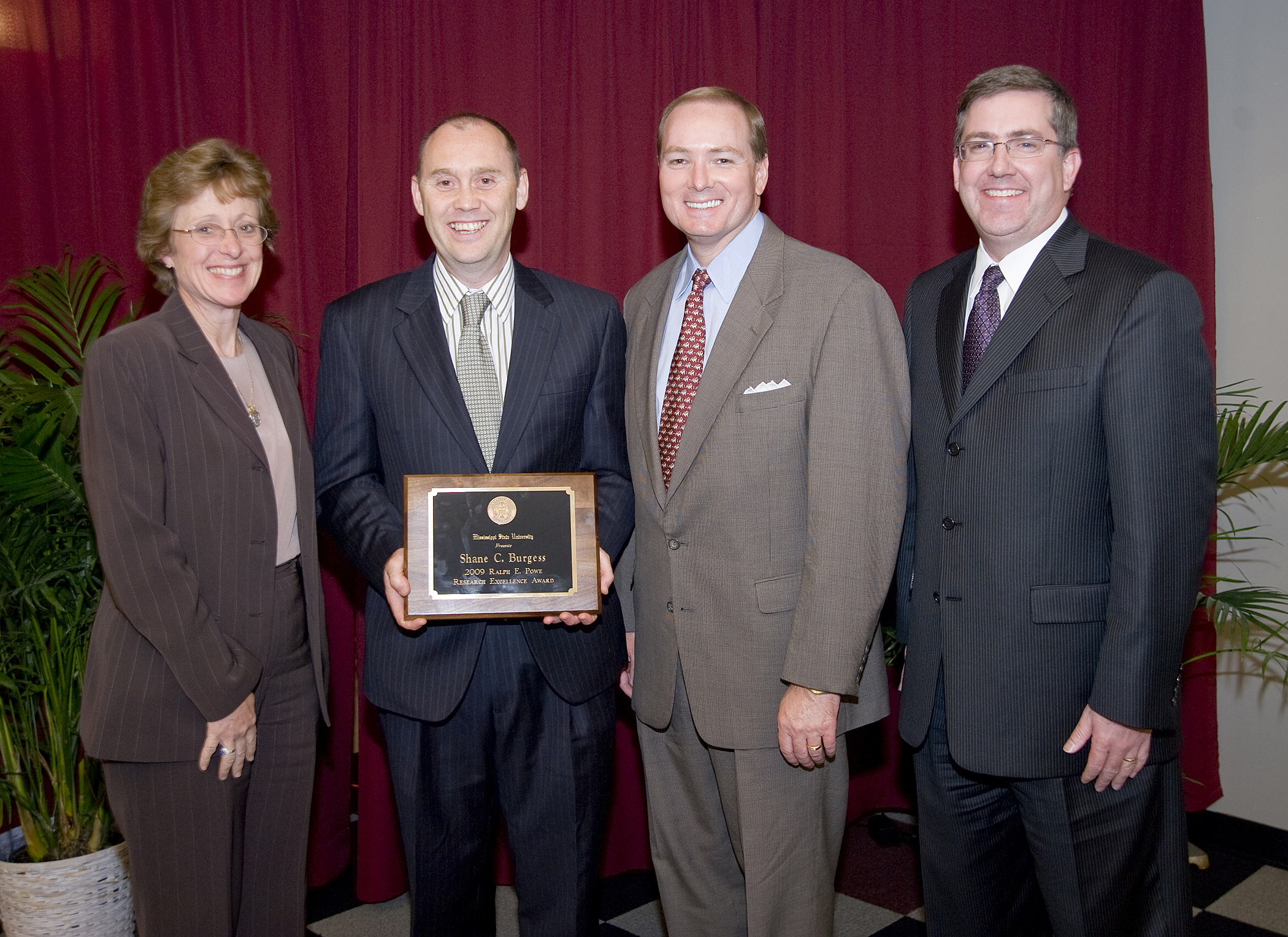 Mississippi State's 2009 Powe Award winner, Dr. Shane Burgess, second from left, is congratulated by Melissa Mixon, interim vice president of agriculture, forestry and veterinary medicine; President Mark Keenum; and Kirk Schulz, vice president of research and economic development. Mississippi State's 2009 Powe Award winner, Dr. Shane Burgess, second from left, is congratulated by Melissa Mixon, interim vice president of agriculture, forestry and veterinary medicine; President Mark Keenum; and Kirk Schulz, vice president of research and economic development.