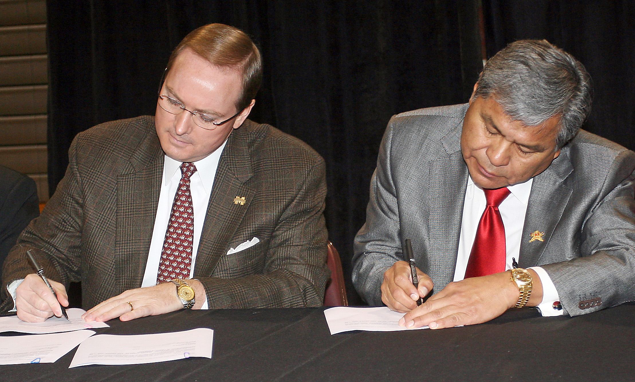 Mississippi State University President Dr. Mark Keenum signs a<br /><br />
Memorandum of Understanding along with Mississippi Band of Choctaw<br /><br />
Indians Miko (Leader) Beasley Denson Friday at the Choctaw Central High School<br /><br />
gymnasium.<br /><br />
Mississippi State University President Dr. Mark Keenum signs a<br /><br />
Memorandum of Understanding along with Mississippi Band of Choctaw<br /><br />
Indians Miko (Leader) Beasley Denson Friday at the Choctaw Central High School<br /><br />
gymnasium.<br /><br />