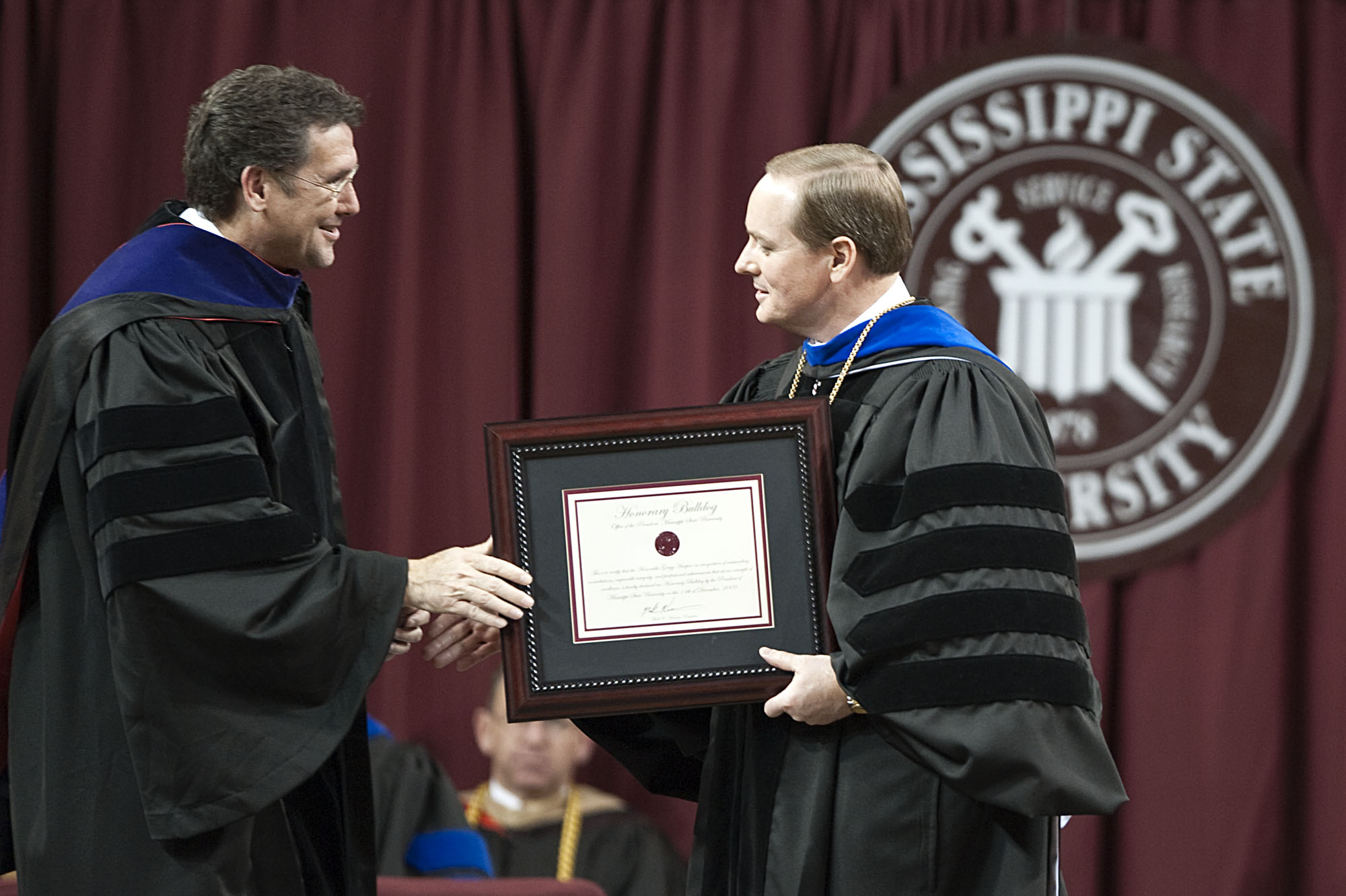 Third District Rep. Greg Harper is presented a certificate recognizing him as an Honorary Bulldog by Mississippi State University's President Mark Keenum. Harper delivered MSU's 2009 fall commencement address Friday night (Dec. 11) in the Humphrey Coliesum where around 1,200 students received degrees. Third District Rep. Greg Harper is presented a certificate recognizing him as an Honorary Bulldog by Mississippi State University's President Mark Keenum. Harper delivered MSU's 2009 fall commencement address Friday night (Dec. 11) in the Humphrey Coliesum where around 1,200 students received degrees.