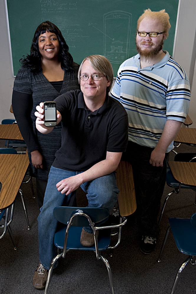 MSU students John van der Zwaag (front), Natasha Pittman and Keni Steward with the phone they use to test the game they developed. MSU students John van der Zwaag (front), Natasha Pittman and Keni Steward with the phone they use to test the game they developed.