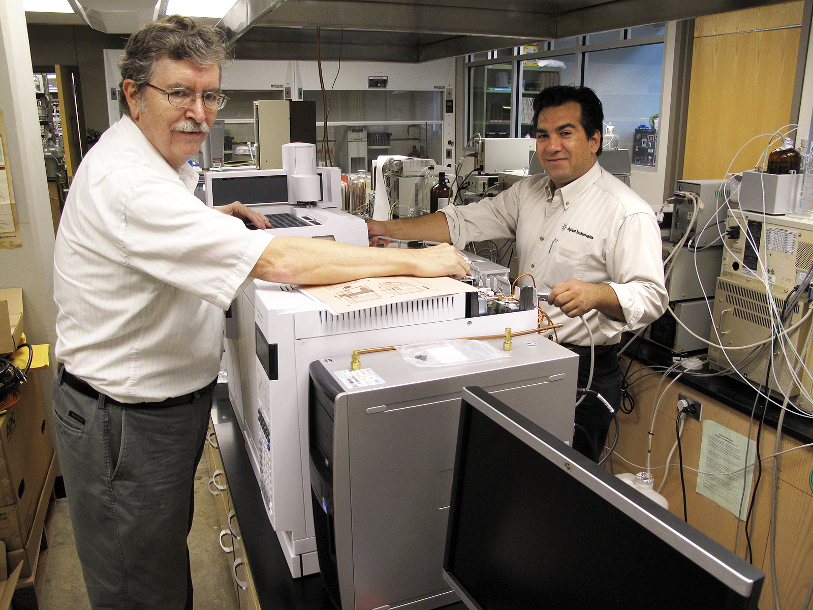 Service engineer Steve Hite (l) and gas chromatography special solutions engineer Mario Morales of Agilent Technologies, Inc., install a high-end mass spectrometer at the Mississippi State Chemical Lab in the Hand Chemical Lab building on the Mississippi State campus. The Delaware-based company donated the use of the high-tech instrument for one year, where it will be used to test Gulf seafood for evidence of oil contamination.