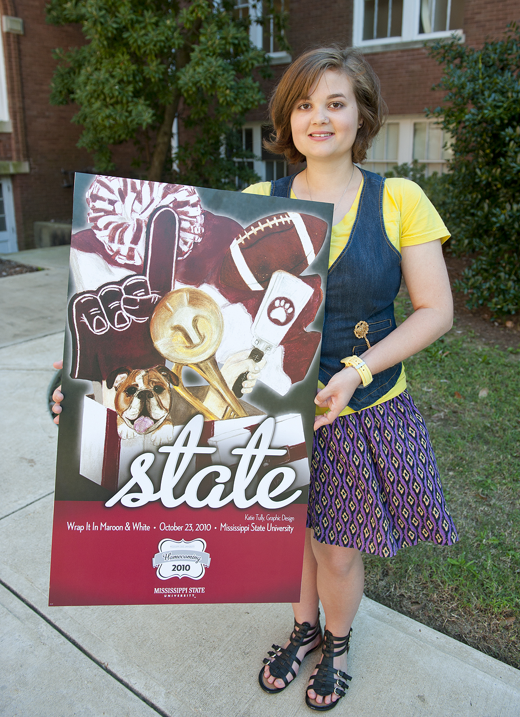 Tully displays her award-winning 2010 Homecoming poster design. Tully displays her award-winning 2010 Homecoming poster design.