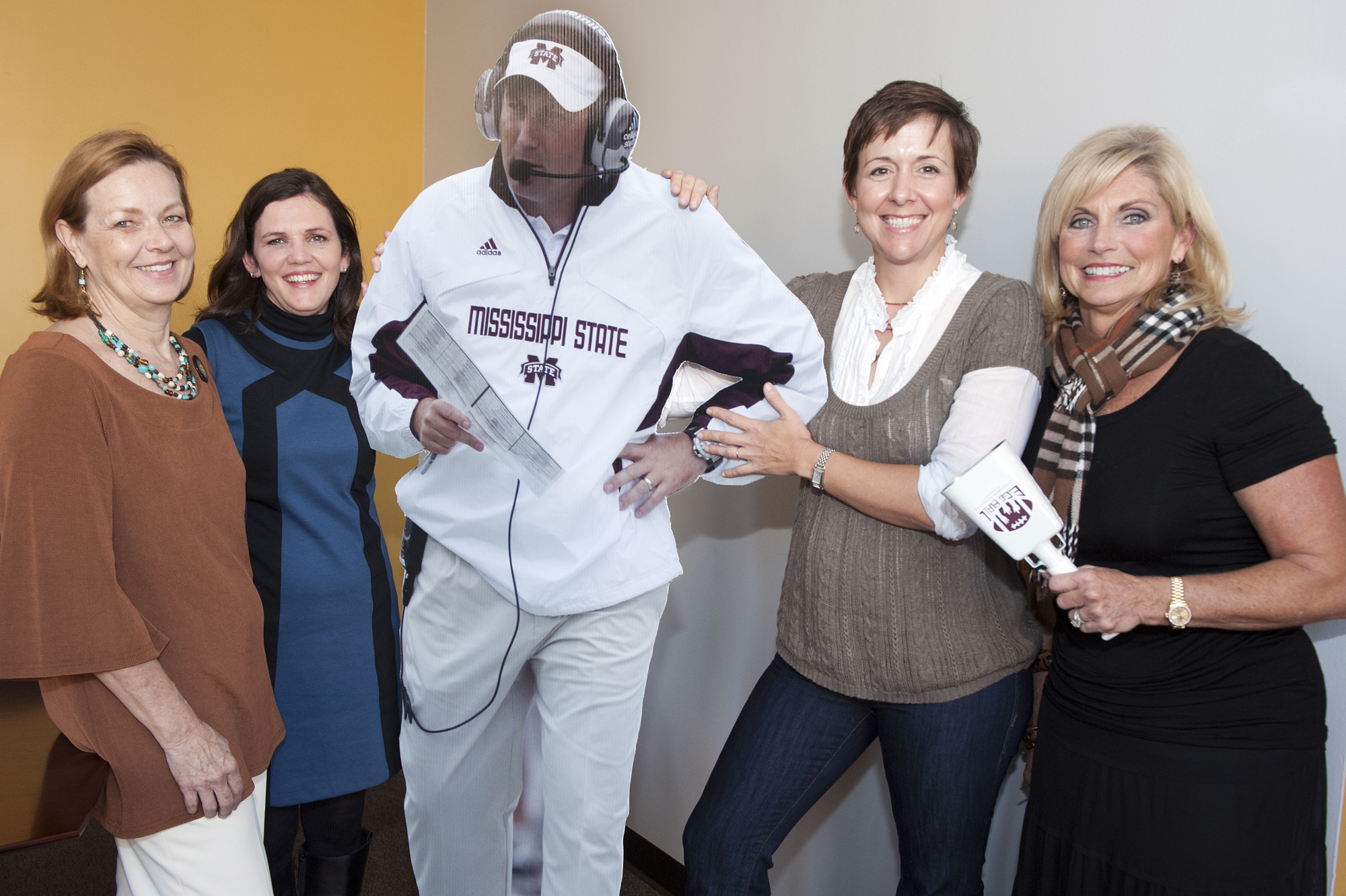 Committee members for the first Mississippi KIDS COUNT Egg Ball hope they get a "larger than life" auction bid on this life-size cutout of MSU Coach Dan Mullen during the event Nov. 26 at 8 p.m. in the Club Level of Davis Wade Stadium. Shown with the realistic carbon copy are, from left, Kim Stevens, Mary Beth Franklin, Nelle Cohen and Janet Mullins. Committee members for the first Mississippi KIDS COUNT Egg Ball hope they get a "larger than life" auction bid on this life-size cutout of MSU Coach Dan Mullen during the event Nov. 26 at 8 p.m. in the Club Level of Davis Wade Stadium. Shown with the realistic carbon copy are, from left, Kim Stevens, Mary Beth Franklin, Nelle Cohen and Janet Mullins.