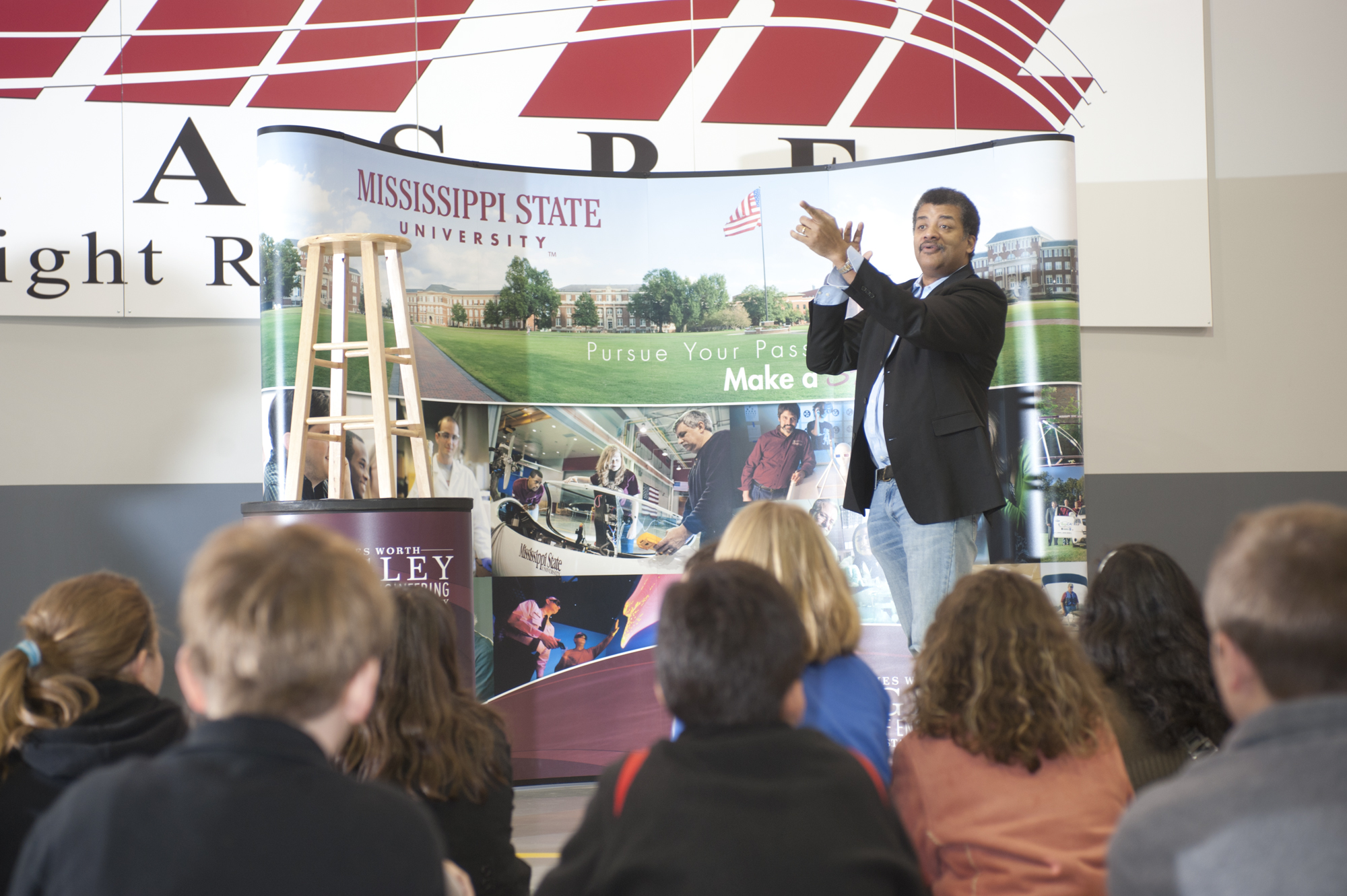Astrophysicist Neil deGrasse Tyson wowed local elementary and middle school students Tuesday, answering questions from "Why isn't Pluto a planet?" to "What will happen when plasma from the sun hits earth?" Astrophysicist Neil deGrasse Tyson wowed local elementary and middle school students Tuesday, answering questions from "Why isn't Pluto a planet?" to "What will happen when plasma from the sun hits earth?"