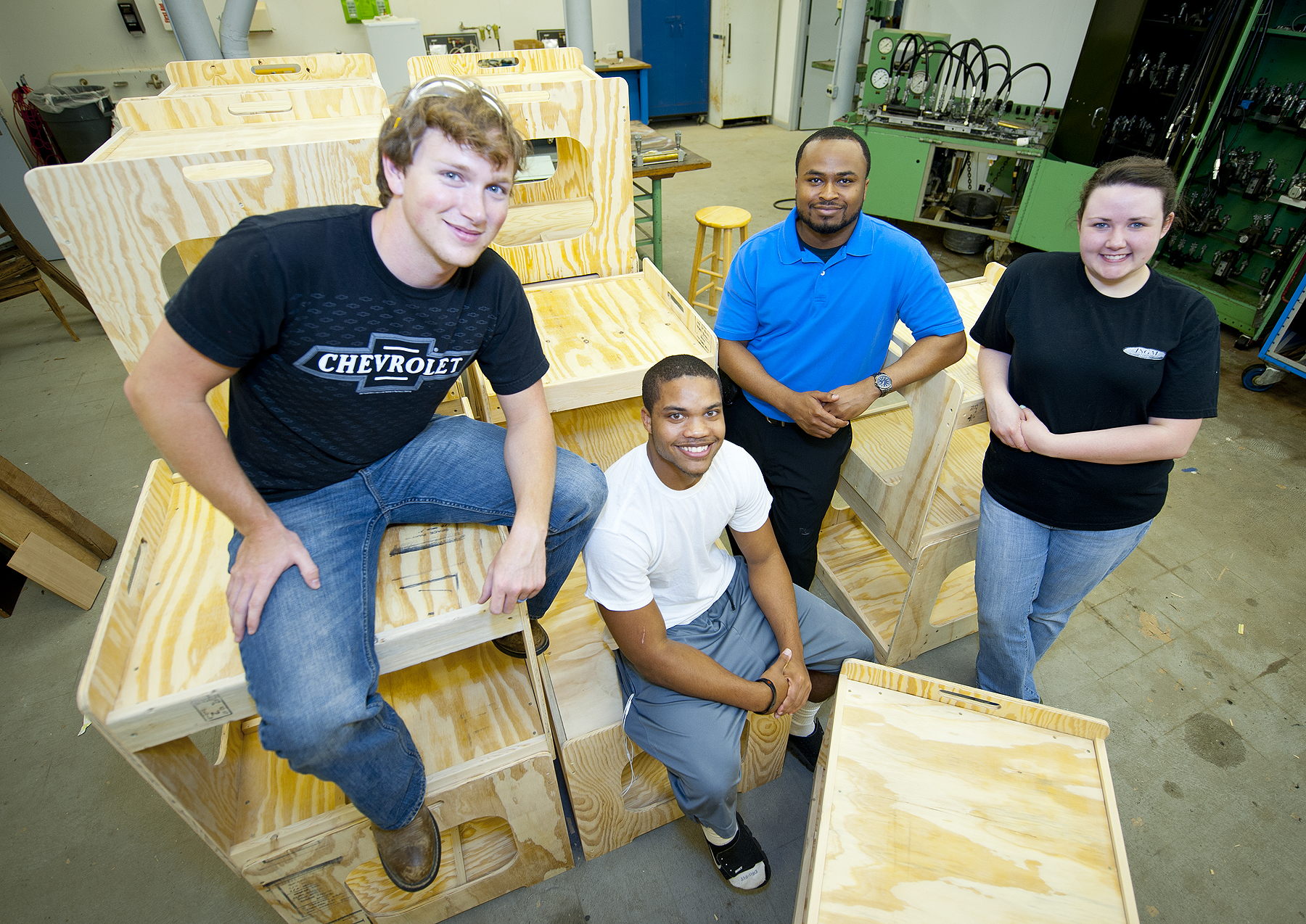 MSU industrial technology majors (front, l-r) Cory Bynum of Southaven, David Wallace of New Orleans, La., and Lara Threet of Eupora, with Polo Custom plant engineer Justin McDonald and wooden carts their class produced. MSU industrial technology majors (front, l-r) Cory Bynum of Southaven, David Wallace of New Orleans, La., and Lara Threet of Eupora, with Polo Custom plant engineer Justin McDonald and wooden carts their class produced.