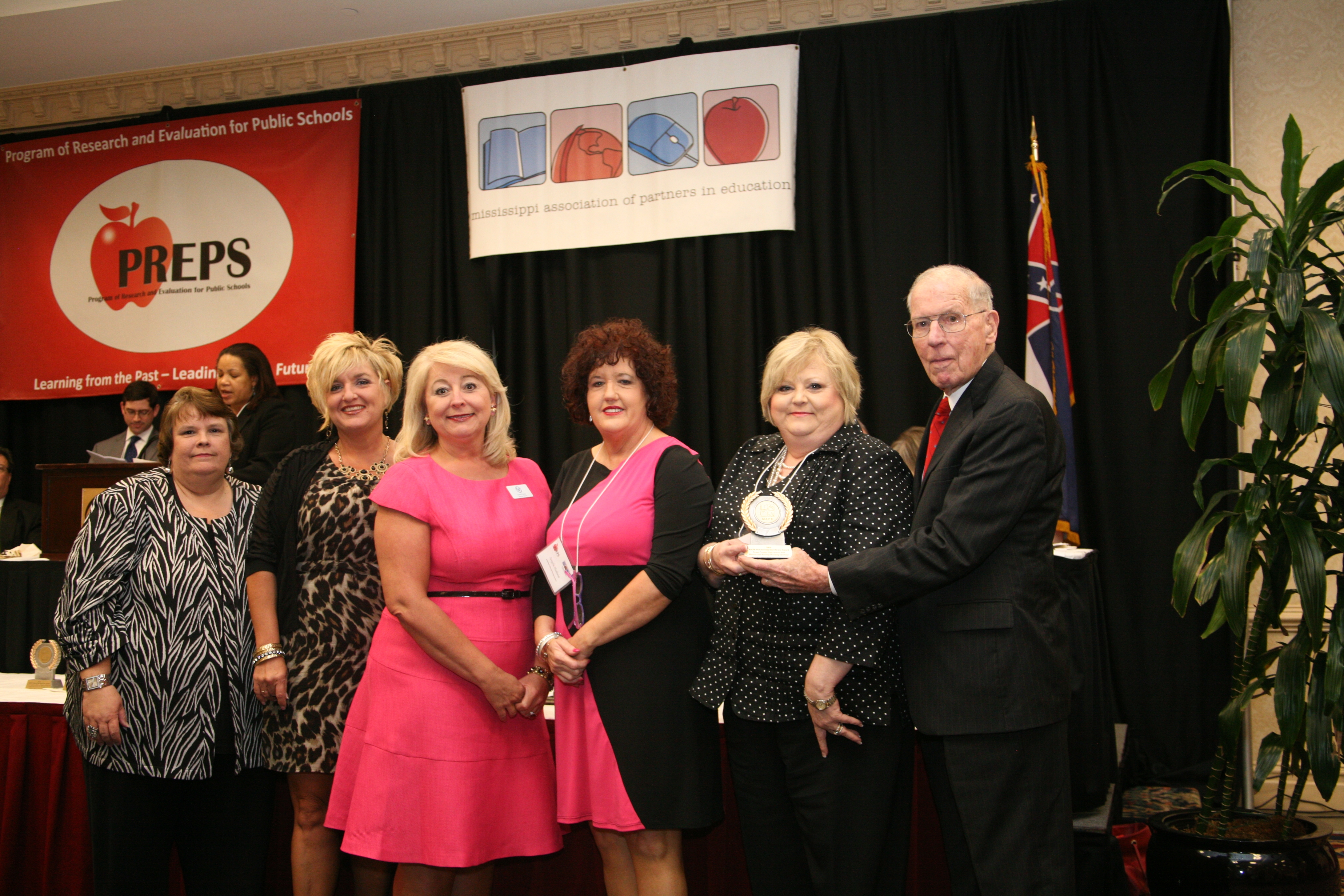 Yazoo County High School and the MSU-based Mississippi Writing/Thinking Institute received a 2012 MAPE Board of Directors Partnership Excellence Award. At the ceremony were (l-r) Debbie Anglin, MAPE president; MWTI director Kim Patterson and associate director Cheryl Foster; and Angela Hudson, federal programs director, and superintendent Rebecca Fisher, both of the Yazoo County School District. Former governor William Winter presented the honor. Yazoo County High School and the MSU-based Mississippi Writing/Thinking Institute received a 2012 MAPE Board of Directors Partnership Excellence Award. At the ceremony were (l-r) Debbie Anglin, MAPE president; MWTI director Kim Patterson and associate director Cheryl Foster; and Angela Hudson, federal programs director, and superintendent Rebecca Fisher, both of the Yazoo County School District. Former governor William Winter presented the honor.