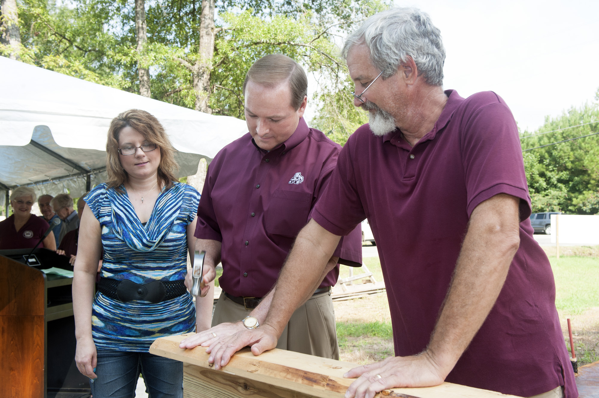 John Breazeale (r) helps MSU President Mark E. Keenum drive the first construction nail of Daphne Walton's (l) Habitat for Humanity-sponsored home. John Breazeale (r) helps MSU President Mark E. Keenum drive the first construction nail of Daphne Walton's (l) Habitat for Humanity-sponsored home.