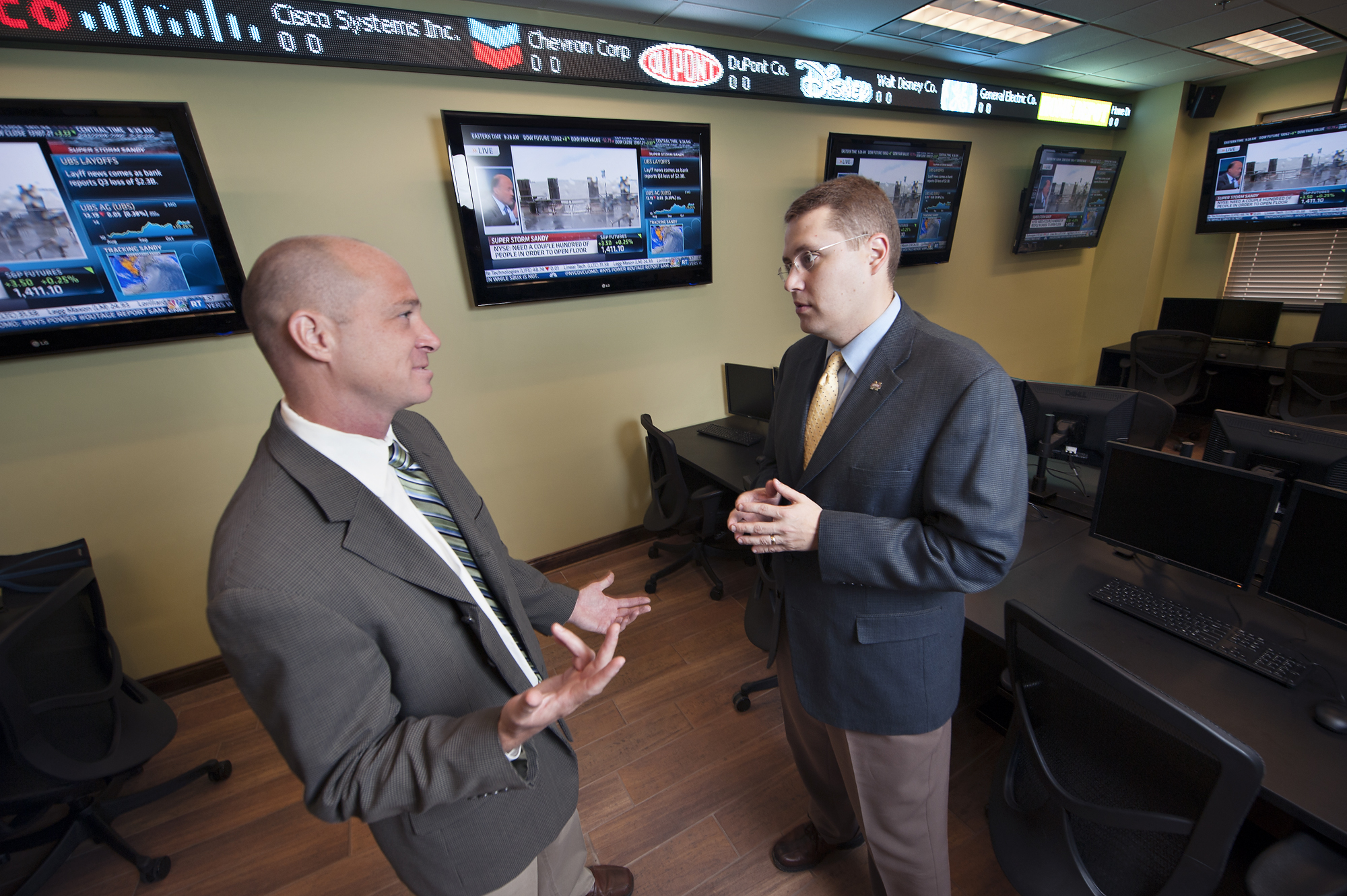 Jon Rezek, left, and Mike Highfield discuss Hurricane Sandy's financial implications at Mississippi State University's new Strategic Finance Laboratory in the College of Business. Rezek, an associate professor of economics, is head of the university's international business program, and Highfield, an associate professor of finance, is head of the finance and economics department. Jon Rezek, left, and Mike Highfield discuss Hurricane Sandy's financial implications at Mississippi State University's new Strategic Finance Laboratory in the College of Business. Rezek, an associate professor of economics, is head of the university's international business program, and Highfield, an associate professor of finance, is head of the finance and economics department.