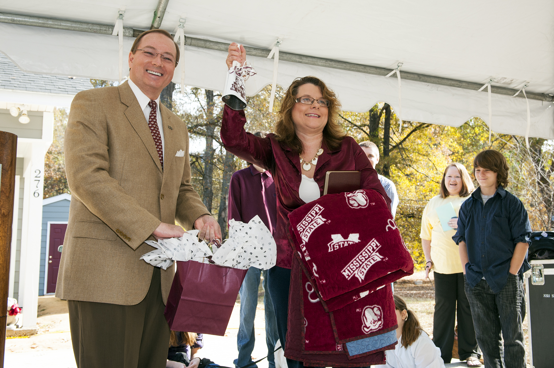 MSU President Mark E. Keenum presents Daphne Walton with a cowbell and a family Bible during the Habitat for Humanity home dedication ceremony. The project is part of MSU's Maroon Edition first-year reading experience. MSU President Mark E. Keenum presents Daphne Walton with a cowbell and a family Bible during the Habitat for Humanity home dedication ceremony. The project is part of MSU's Maroon Edition first-year reading experience.