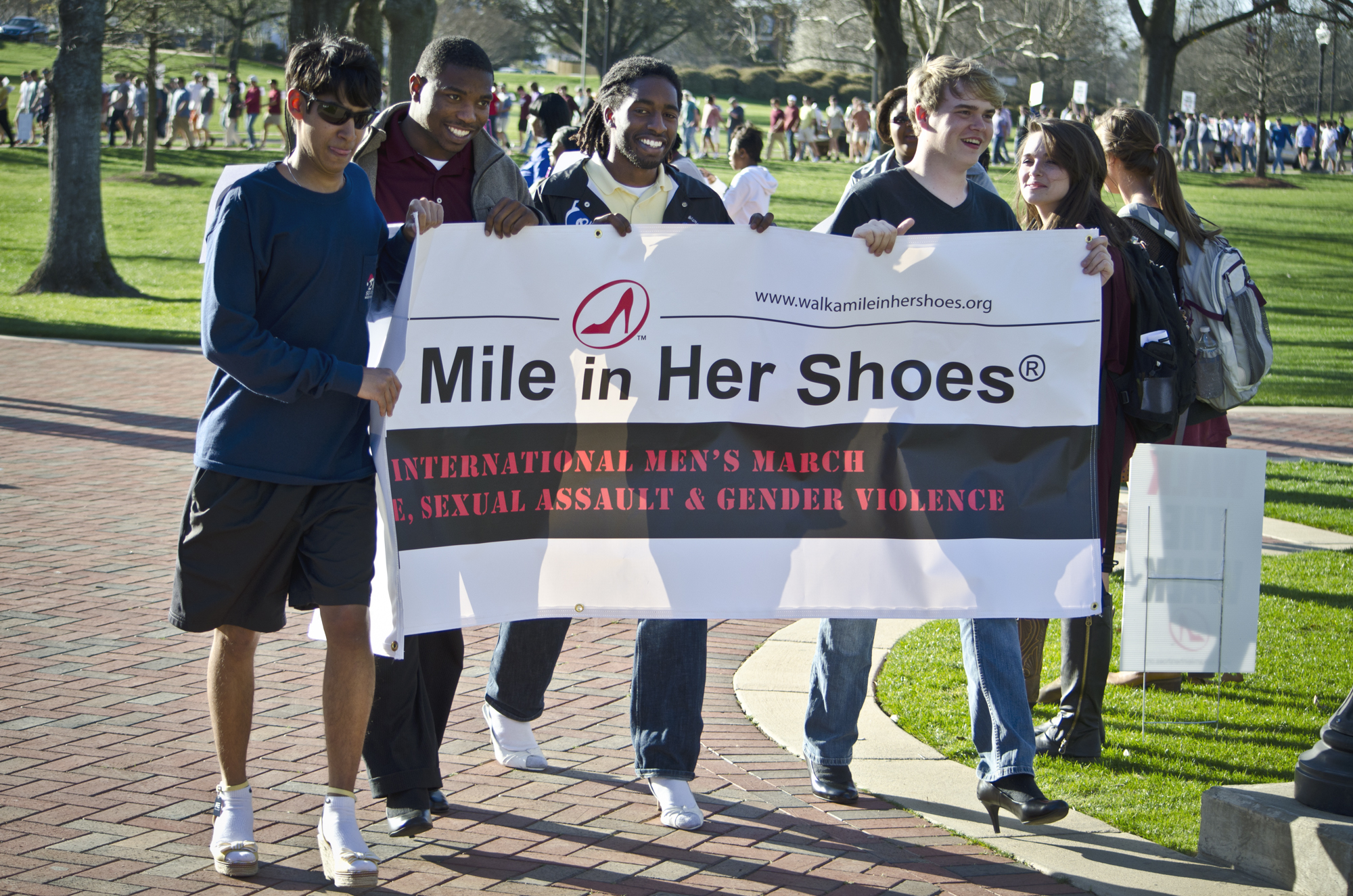 "Walk a Mile in Her Shoes" participants carry a banner during last year's event. On Tuesday, more than 500 are expected to turn out to support awareness of relationship violence and sexual assault. "Walk a Mile in Her Shoes" participants carry a banner during last year's event. On Tuesday, more than 500 are expected to turn out to support awareness of relationship violence and sexual assault.