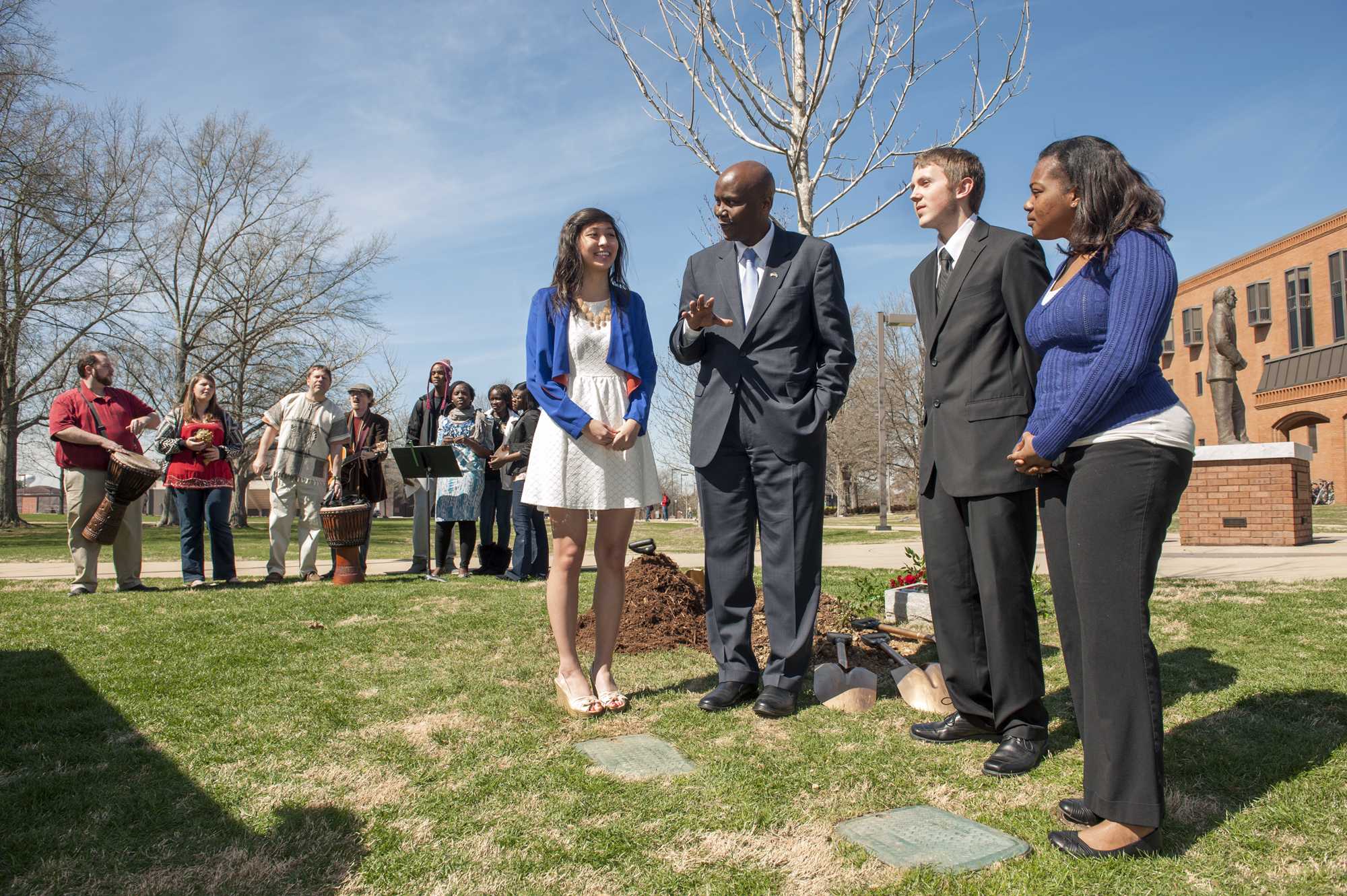 Kenyan Ambassador Elkanah Odembo, center, visits with three Mississippi State student winners of an essay contest the university held in conjunction with the reading of "Unbowed," by Wangari Maathai. The ambassador knew fellow Kenyan Maathai well, and he said the ceremonial tree planting in her memory at MSU Monday also was an appropriate way to honor Kenya, which held its first election since approval of its new constitution. As members of the African Student Association perform in the background, chemistry major Catherine Feng, left, and aerospace engineering major Jacob Stephens and biological sciences major Miata Morgan enjoy the opportunity to speak with Odembo. Kenyan Ambassador Elkanah Odembo, center, visits with three Mississippi State student winners of an essay contest the university held in conjunction with the reading of "Unbowed," by Wangari Maathai. The ambassador knew fellow Kenyan Maathai well, and he said the ceremonial tree planting in her memory at MSU Monday also was an appropriate way to honor Kenya, which held its first election since approval of its new constitution. As members of the African Student Association perform in the background, chemistry major Catherine Feng, left, and aerospace engineering major Jacob Stephens and biological sciences major Miata Morgan enjoy the opportunity to speak with Odembo.