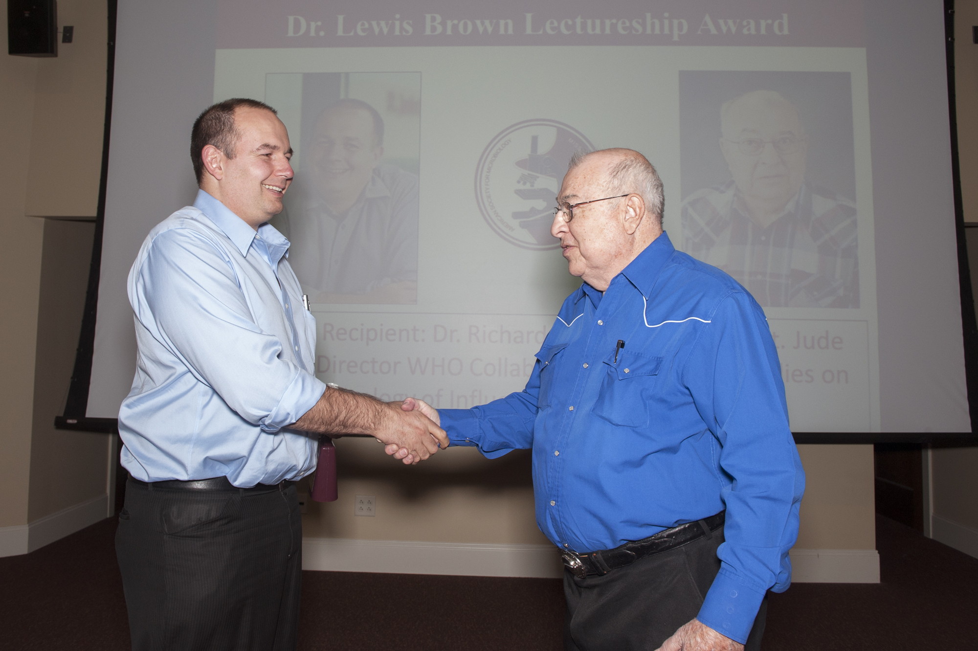 St. Jude's Research Hospital virologist Richard J. Webby, left, accepts the Dr. Lewis Brown Lectureship Award from Brown himself, a research professor emeritus at Mississippi State University. The award is sponsored by the MSU Student Chapter of the American Society for Microbiology. St. Jude's Research Hospital virologist Richard J. Webby, left, accepts the Dr. Lewis Brown Lectureship Award from Brown himself, a research professor emeritus at Mississippi State University. The award is sponsored by the MSU Student Chapter of the American Society for Microbiology.
