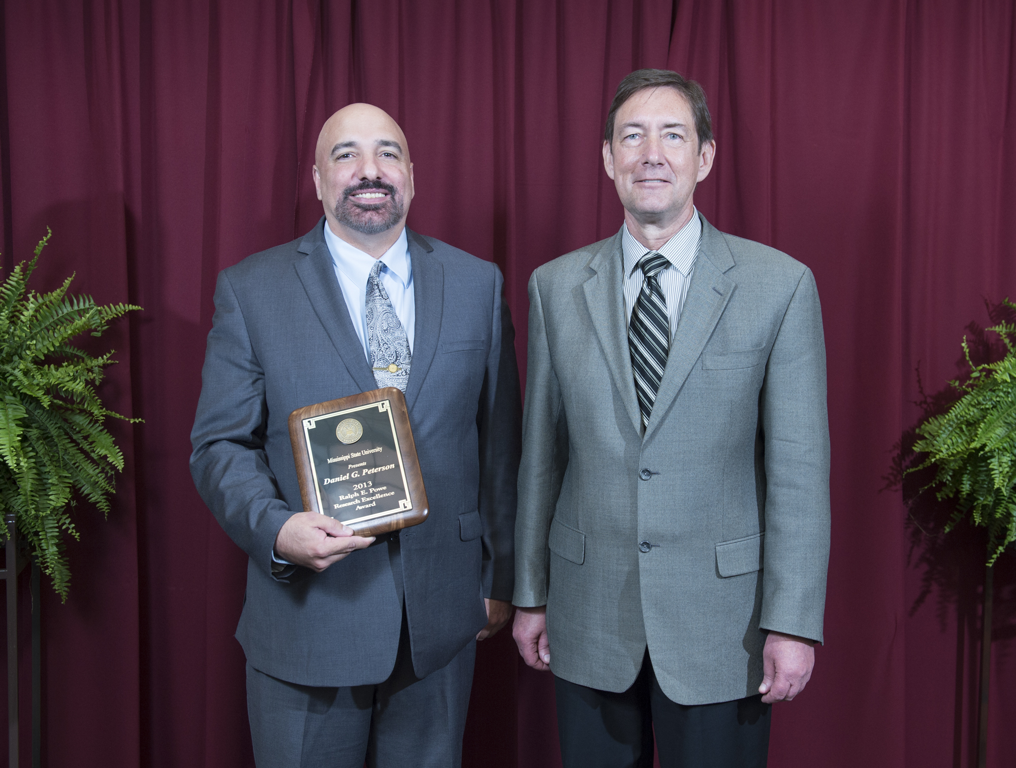 Plant and soil sciences department professor Daniel G. Peterson, left, the winner of the 2013 Ralph E. Powe Research Excellence Award, was congratulated by Greg Bohach, vice president for agriculture, forestry and veterinary medicine. Plant and soil sciences department professor Daniel G. Peterson, left, the winner of the 2013 Ralph E. Powe Research Excellence Award, was congratulated by Greg Bohach, vice president for agriculture, forestry and veterinary medicine.