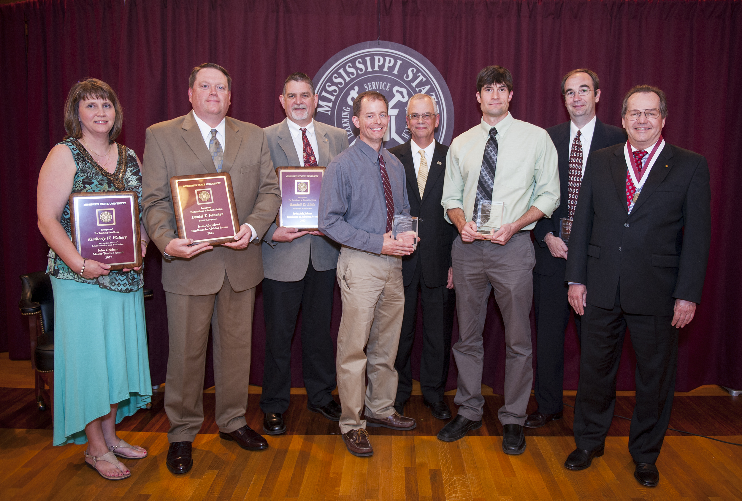 MSU's 2013 faculty award winners include (from left) Kimberly Walters, Daniel "Tim" Fancher, Randall Little, Gary Ervin, Josh Winter, Joel Collier, and Mark Novotny. Jerry Gilbert (fourth from right), provost and executive vice president, is pictured extending congratulations to the recent honorees during the university's annual Faculty Awards and Recognition Program.