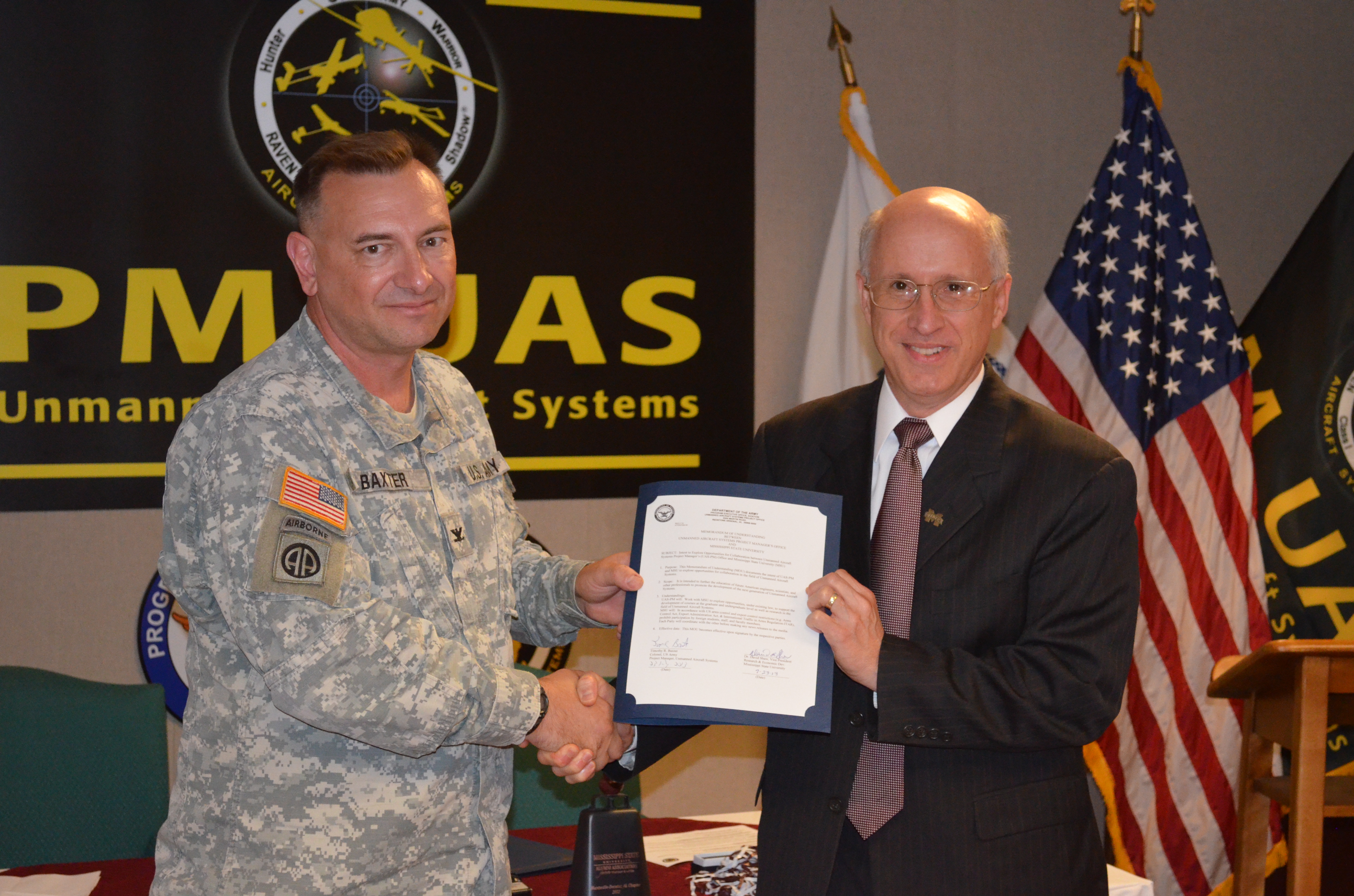 Tuesday morning, Col. Tim Baxter (l), project manager for Unmanned Aircraft Systems, and David Shaw, MSU vice president for research and economic development, signed a memorandum of understanding to facilitate collaborative research opportunities between the Army and MSU.