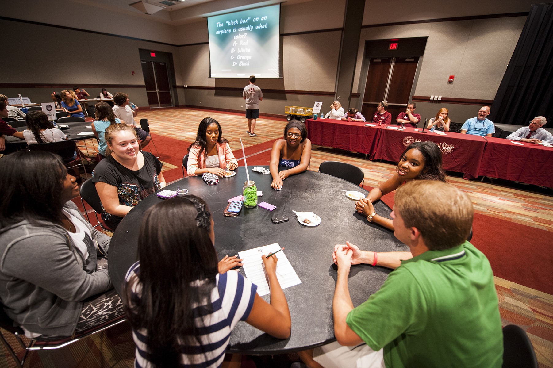 College Ready Program participants at MSU work as a team to answer questions during a trivia night competition against their professors. College Ready Program participants at MSU work as a team to answer questions during a trivia night competition against their professors.