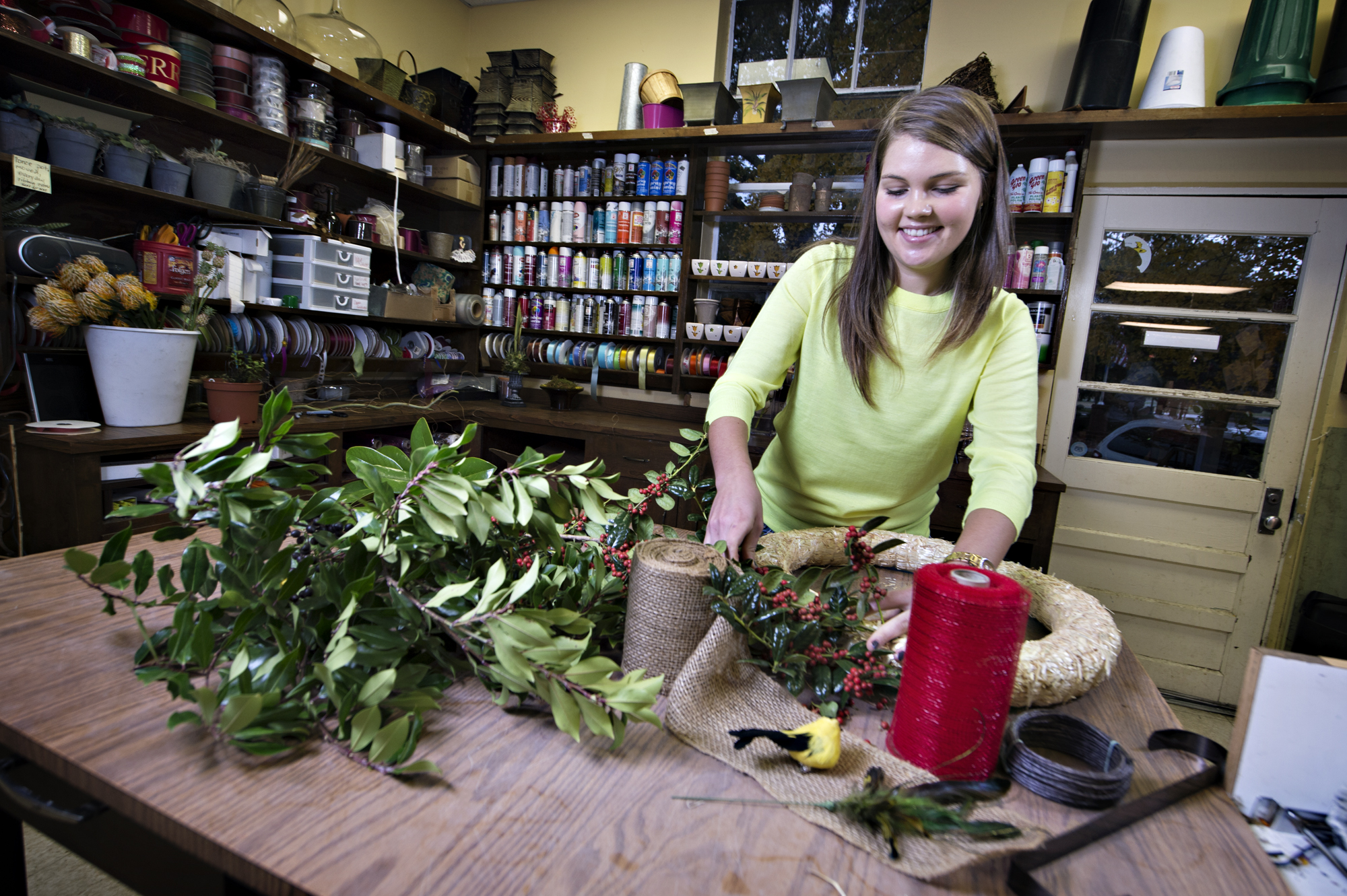 MSU junior Darby Dillard, vice president of the student chapter of the American Institute of Floral Designers, prepares an evergreen wreath at the University Florist. MSU junior Darby Dillard, vice president of the student chapter of the American Institute of Floral Designers, prepares an evergreen wreath at the University Florist.