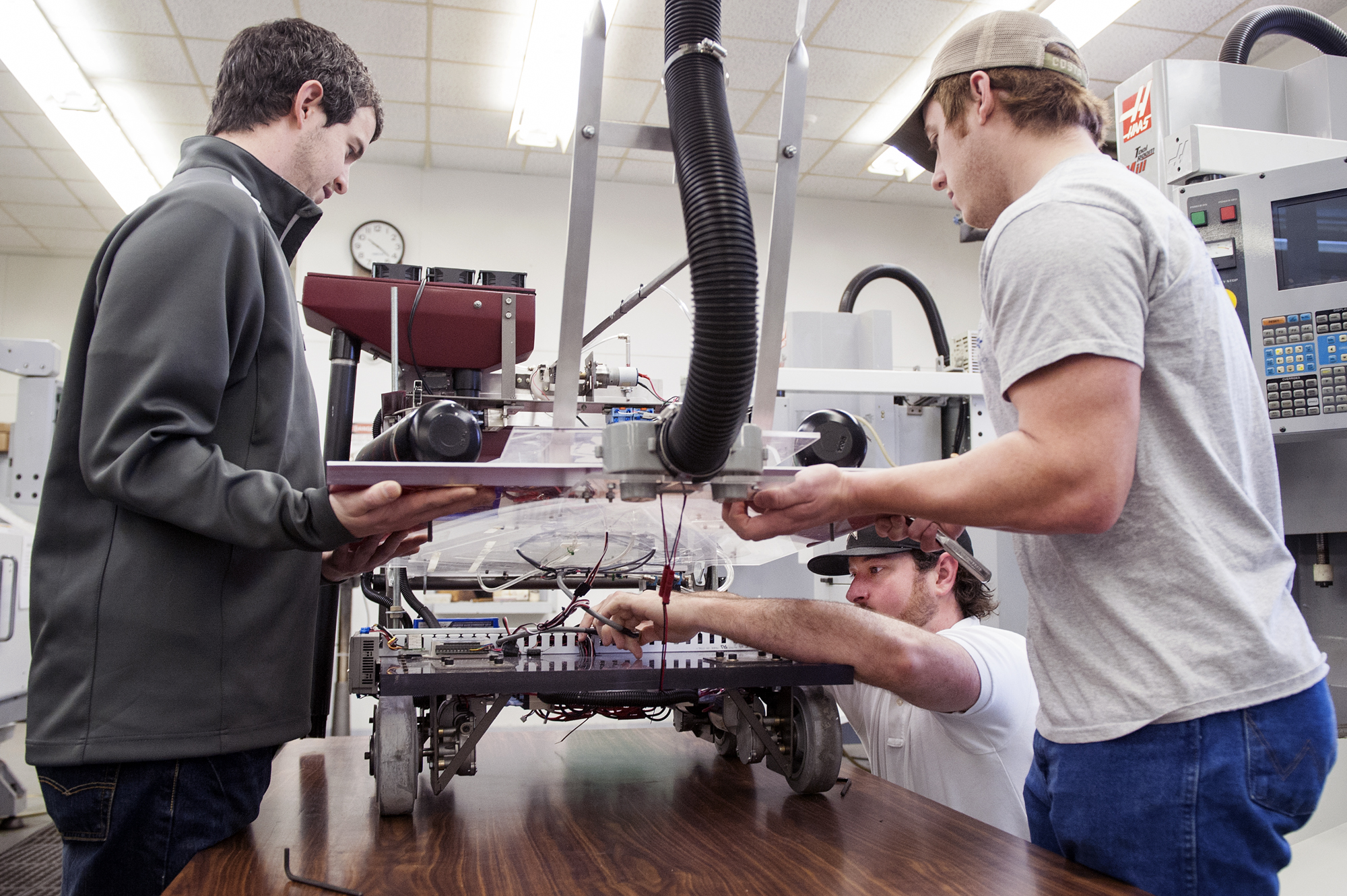 Mississippi State industrial technology students won top awards in the Robotics Competition at the recent Association of Technology, Management and Applied Engineering conference. Seniors Riley Boren, left, and Josh Lyles hold up the robot for Trey Tavares to adjust wires. Mississippi State industrial technology students won top awards in the Robotics Competition at the recent Association of Technology, Management and Applied Engineering conference. Seniors Riley Boren, left, and Josh Lyles hold up the robot for Trey Tavares to adjust wires.