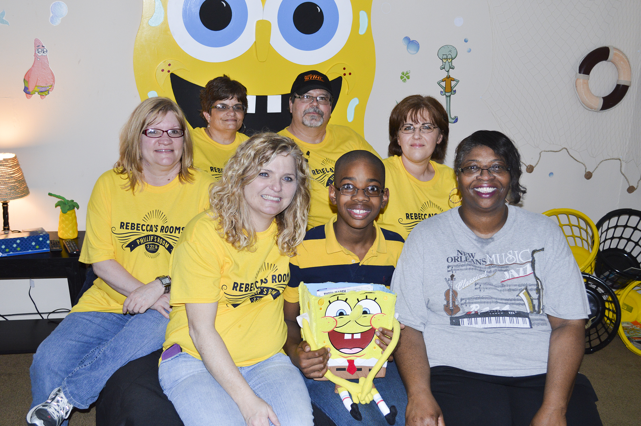 Lowndes County-based Rebecca's Rooms recently remodeled a bedroom for Columbus teen Philip Gandy, center. With volunteer support, the nonprofit organization does the same for other special needs children across the Golden Triangle. In front, from left, are board member Denene Thomason, Philip and his mother Phyllis Gandy. In back, from left, are board members Melissa Kellum and MSU Center for Distance Education employee Mindy Matherne, and founders Reid and Cindy Carter. Also involved along with MSU's Center for Distance Education is the College of Architecture, Art and Design.