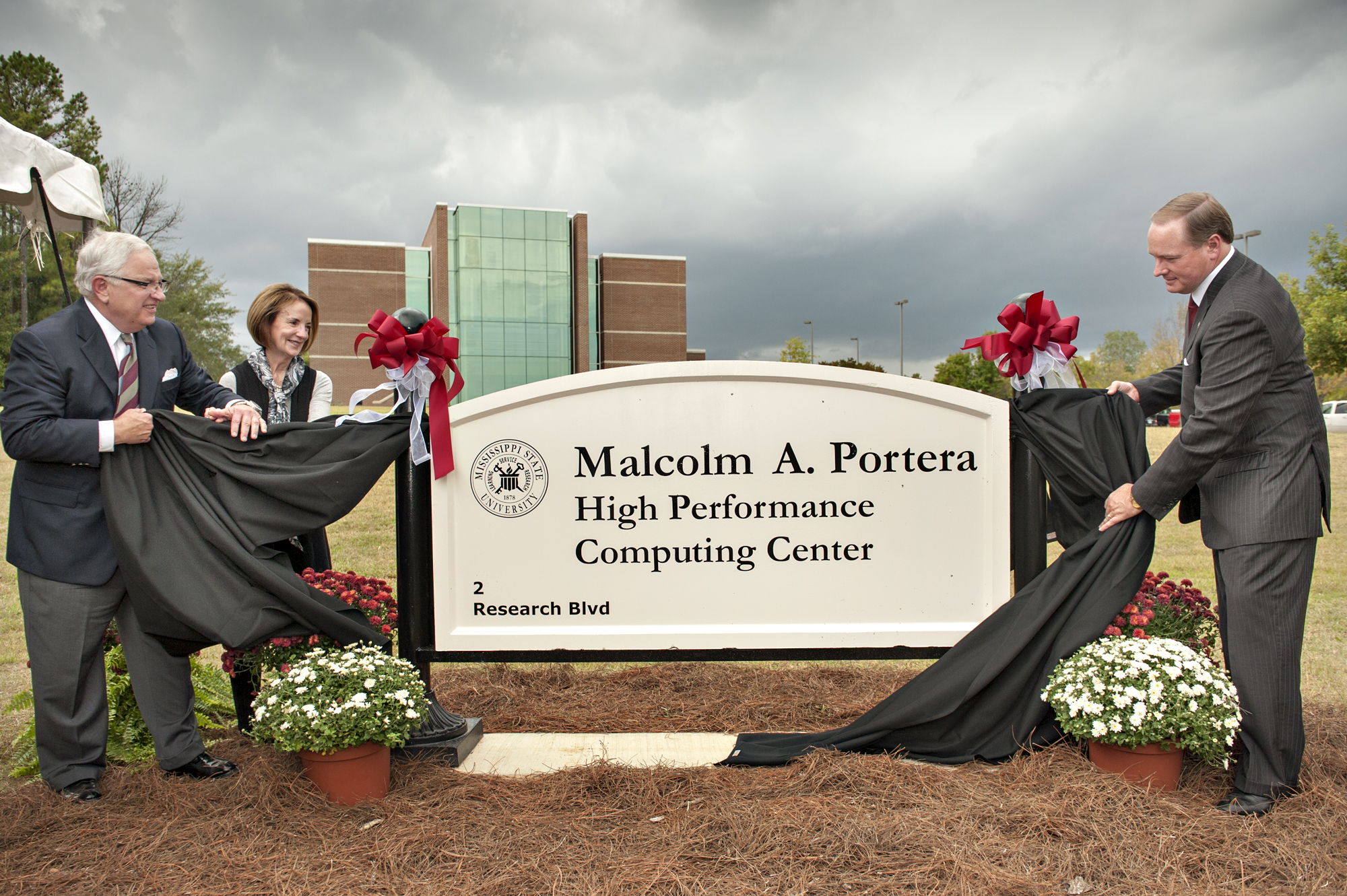 Mississippi State University dedicated the Malcolm A. Portera High Performance Computing Center in honor of the institution's 16th president. From left, Portera, his wife Olivia and MSU President Mark E. Keenum unveil the sign in front of the center. Mississippi State University dedicated the Malcolm A. Portera High Performance Computing Center in honor of the institution's 16th president. From left, Portera, his wife Olivia and MSU President Mark E. Keenum unveil the sign in front of the center.