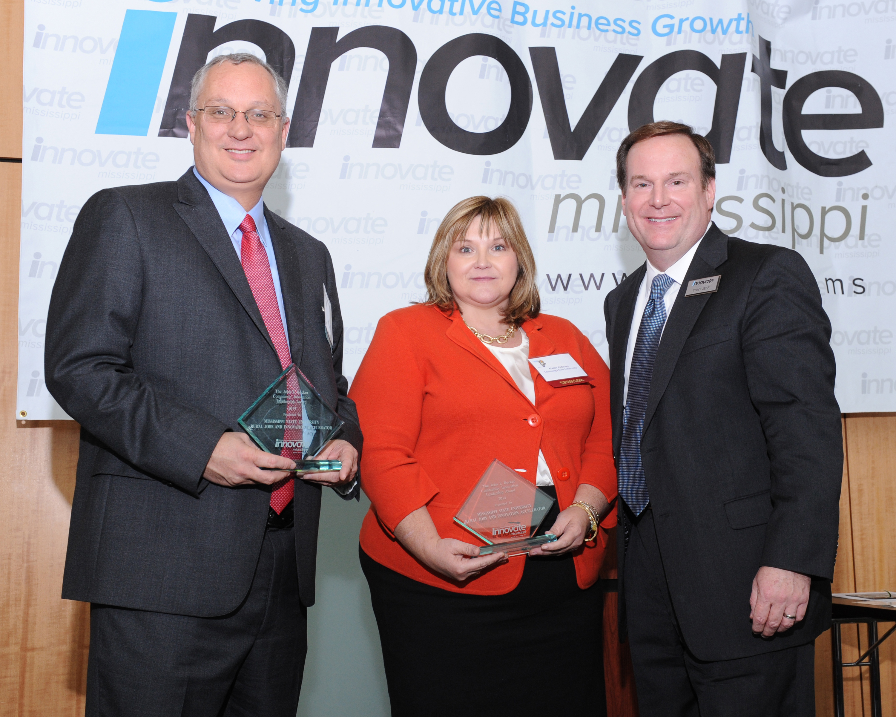 Mississippi State's Clay Walden (l-r) and Kathy Gelston receive on behalf of the university-led Rural Jobs and Innovation Accelerator Program the John I. Rucker Community Innovation Leadership Award from Tony Jeff, president and CEO of Innovate Mississippi, at the Conference on Innovation luncheon in early November.