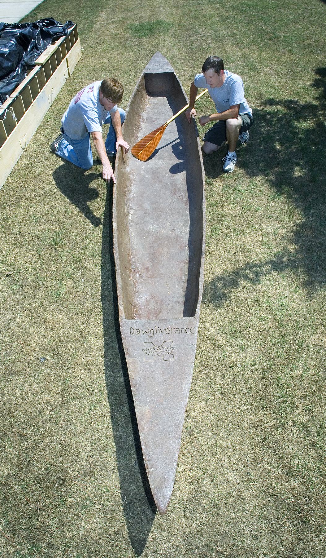 Austin Moore of Jackson (l) and Jesse Doyle of Picayune inspect MSU's 330-pound concrete racing canoe. Austin Moore of Jackson (l) and Jesse Doyle of Picayune inspect MSU's 330-pound concrete racing canoe.