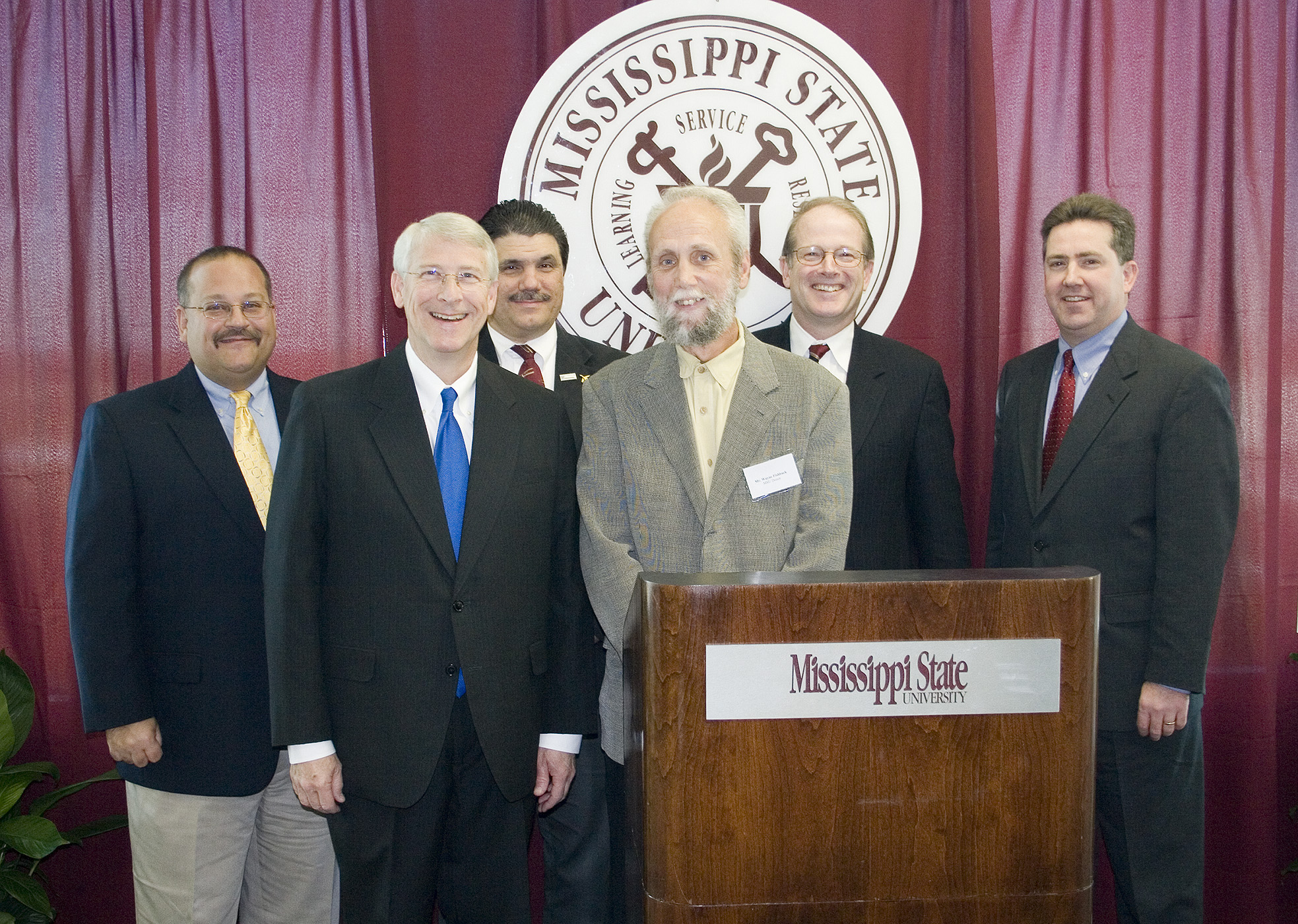 Announcing plans for location of a Mississippi State aerospace engineering center at the Golden Triangle Regional Airport Tuesday were (front, l-r) U.S. Rep. Roger Wicker, R-Miss., and Wayne Fishback of Simi Valley, Calif., who is donating land for the project; and (back, l-r) Joe Higgins, CEO of the Columbus-Lowndes Development Link; Tony Vizzini, head of MSU's aerospace engineering department; Colin Scanes, MSU vice president for research and economic development; and Kirk Schulz, dean of MSU's Bagley College of Engineering. Announcing plans for location of a Mississippi State aerospace engineering center at the Golden Triangle Regional Airport Tuesday were (front, l-r) U.S. Rep. Roger Wicker, R-Miss., and Wayne Fishback of Simi Valley, Calif., who is donating land for the project; and (back, l-r) Joe Higgins, CEO of the Columbus-Lowndes Development Link; Tony Vizzini, head of MSU's aerospace engineering department; Colin Scanes, MSU vice president for research and economic development; and Kirk Schulz, dean of MSU's Bagley College of Engineering.