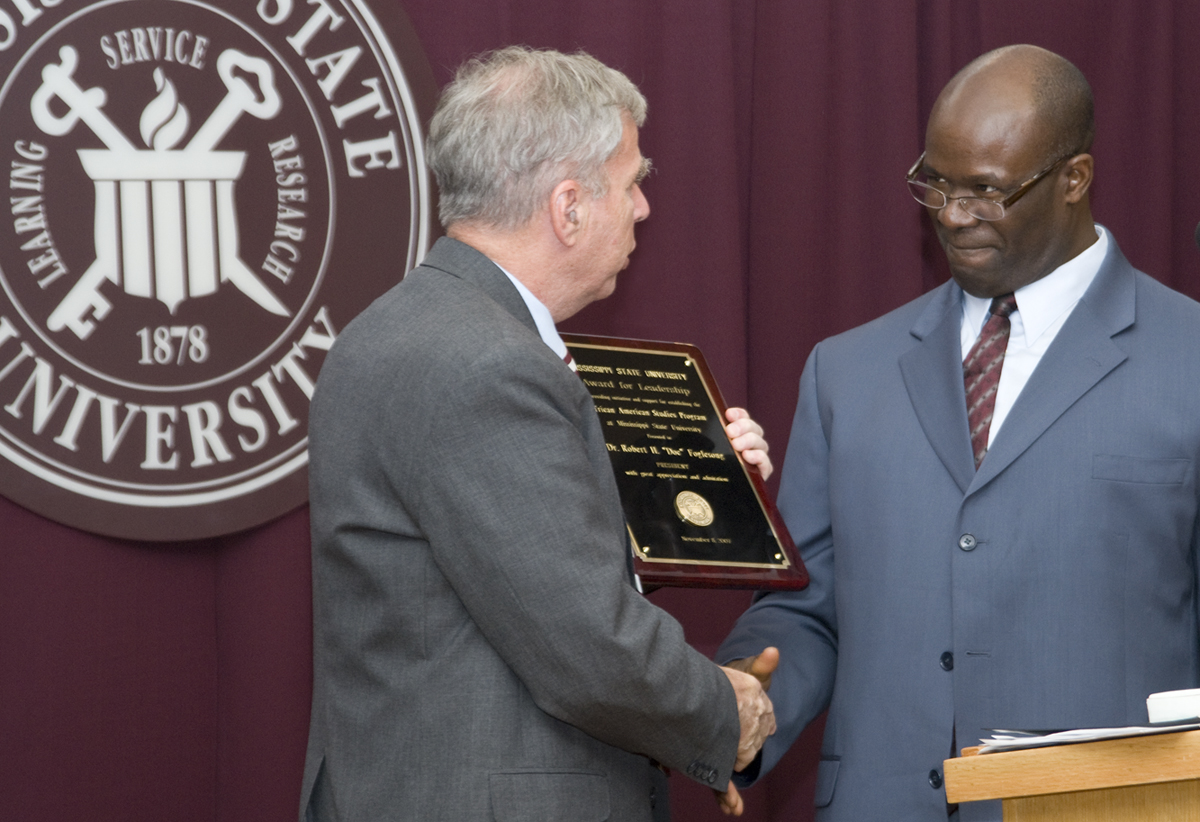 Director Stephen Middleton (r) presented the African-American studies program's first leadership award to MSU President Robert H. "Doc" Foglesong. Director Stephen Middleton (r) presented the African-American studies program's first leadership award to MSU President Robert H. "Doc" Foglesong.