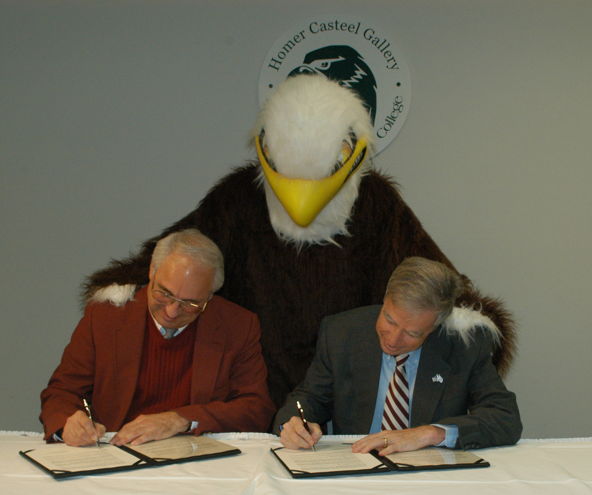 As Meridian Community College's eagle mascot looks on, presidents Scott Elliot (1) and Robert Foglesong sign the MCC-MSU agreement. As Meridian Community College's eagle mascot looks on, presidents Scott Elliot (1) and Robert Foglesong sign the MCC-MSU agreement.