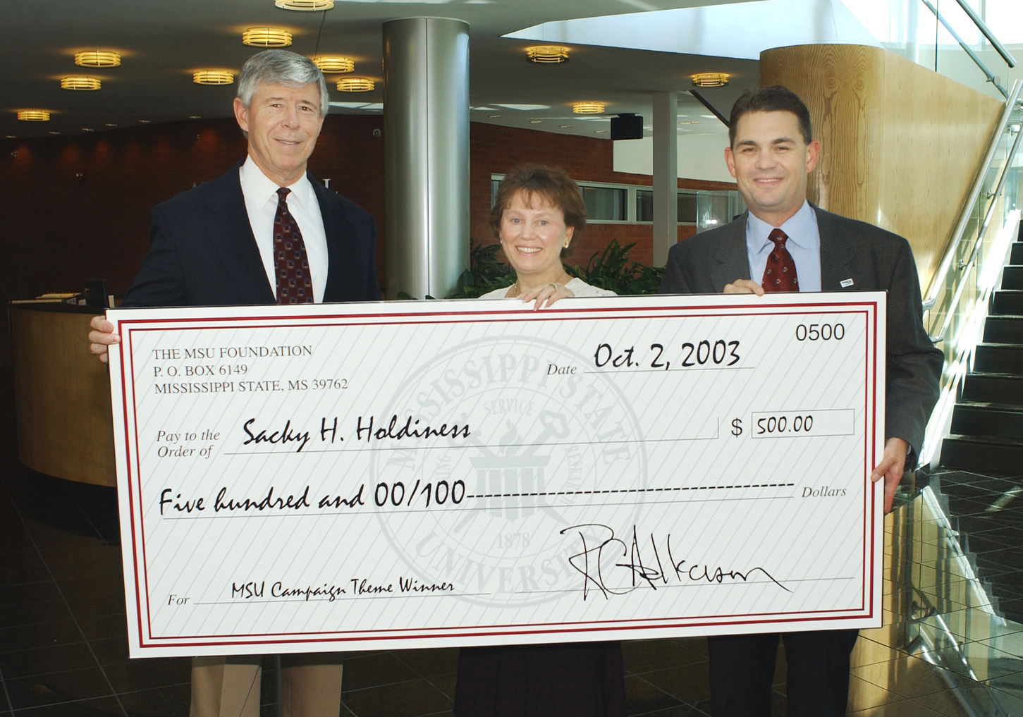 <br /><br />
Sacky Holdiness displays her $500 check with the help of MSU Foundation Executive Director Richard Armstrong (l) and Dennis Prescott, vice president for external affairs. <br /><br />
Sacky Holdiness displays her $500 check with the help of MSU Foundation Executive Director Richard Armstrong (l) and Dennis Prescott, vice president for external affairs.