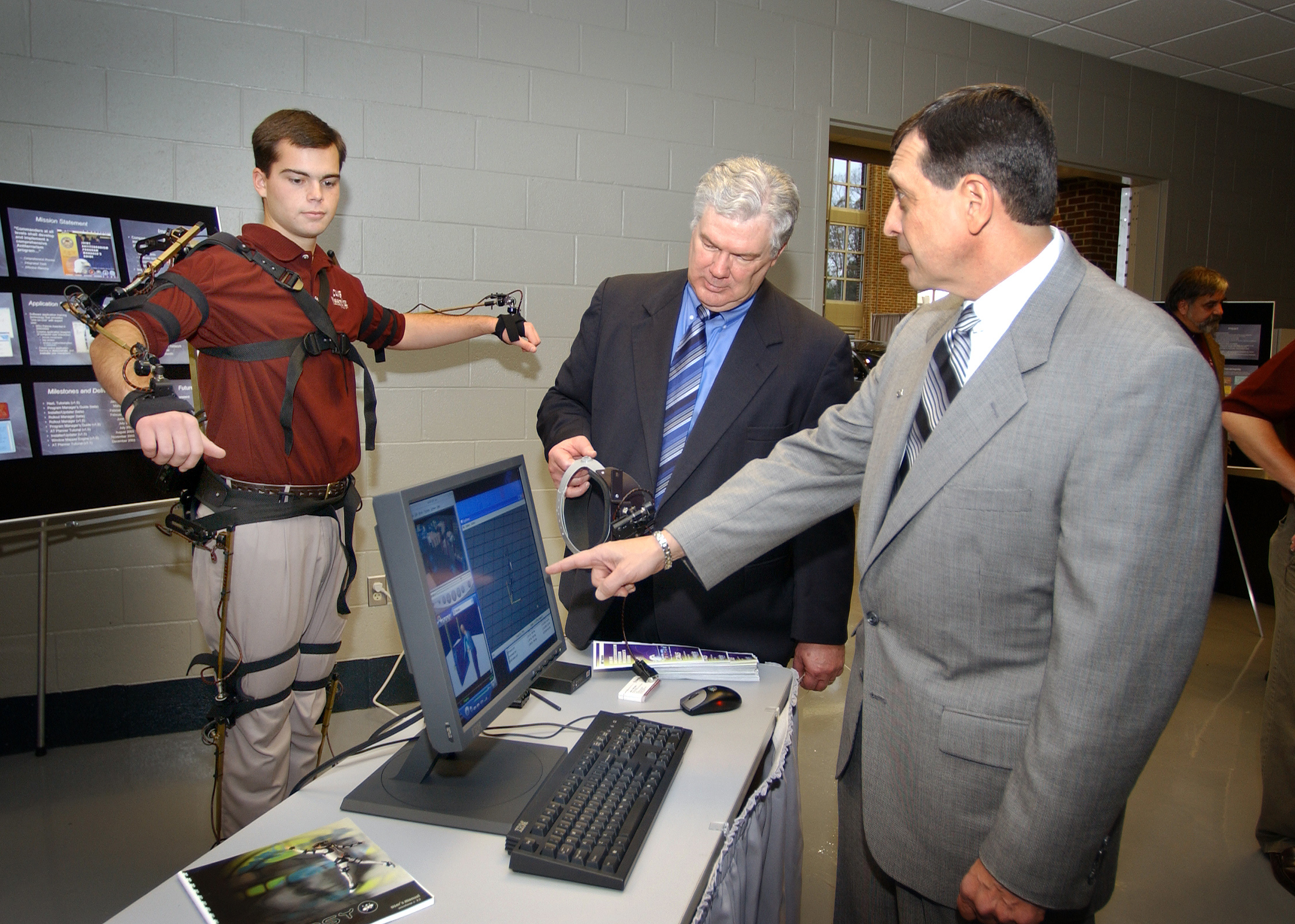 <br /><br />
Mechanical engineering freshman Brandon Witbeck (l) of Starkville demonstrated a motion capture suit Thursday during opening ceremonies for Mississippi State University's Center for Advanced Vehicular Systems. Looking on at the new Starkville facility were J. Donald Trotter (c), CAVS interim director, and John P. Calandro, Nissan director of human relations and administration.<br /><br />
<br /><br />
Mechanical engineering freshman Brandon Witbeck (l) of Starkville demonstrated a motion capture suit Thursday during opening ceremonies for Mississippi State University's Center for Advanced Vehicular Systems. Looking on at the new Starkville facility were J. Donald Trotter (c), CAVS interim director, and John P. Calandro, Nissan director of human relations and administration.<br /><br />