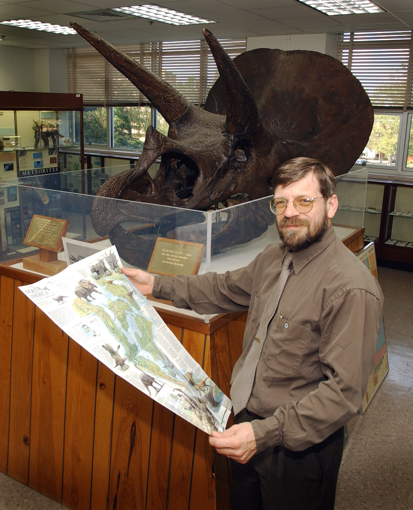 <br /><br />
Chris Dewey and triceratops in MSU's Dunn-Seiler Museum <br /><br />
Chris Dewey and triceratops in MSU's Dunn-Seiler Museum