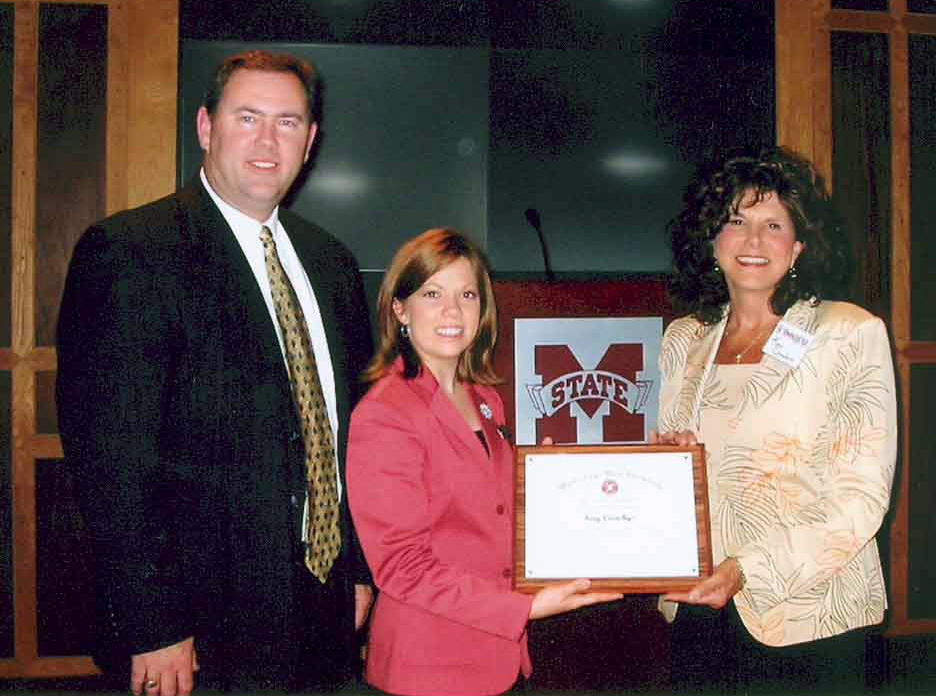 Kay Coachys (r) received the MSU award from senior Schillig Scholar Lindsay Buffum of Jackson as Oak Grove principal Wayne Folkes looked on. Kay Coachys (r) received the MSU award from senior Schillig Scholar Lindsay Buffum of Jackson as Oak Grove principal Wayne Folkes looked on.