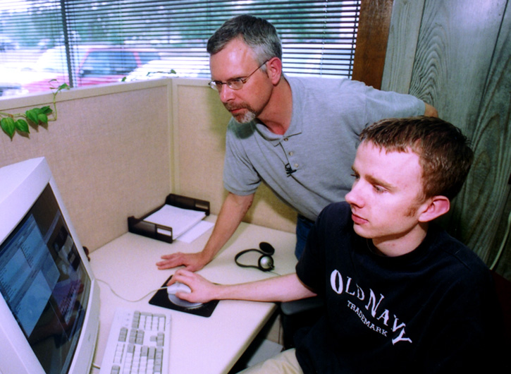 <br /><br />
MSU senior research associate Scott Calhoun (standing) and computer science major Matthew Bennet of New Albany <br /><br />
MSU senior research associate Scott Calhoun (standing) and computer science major Matthew Bennet of New Albany