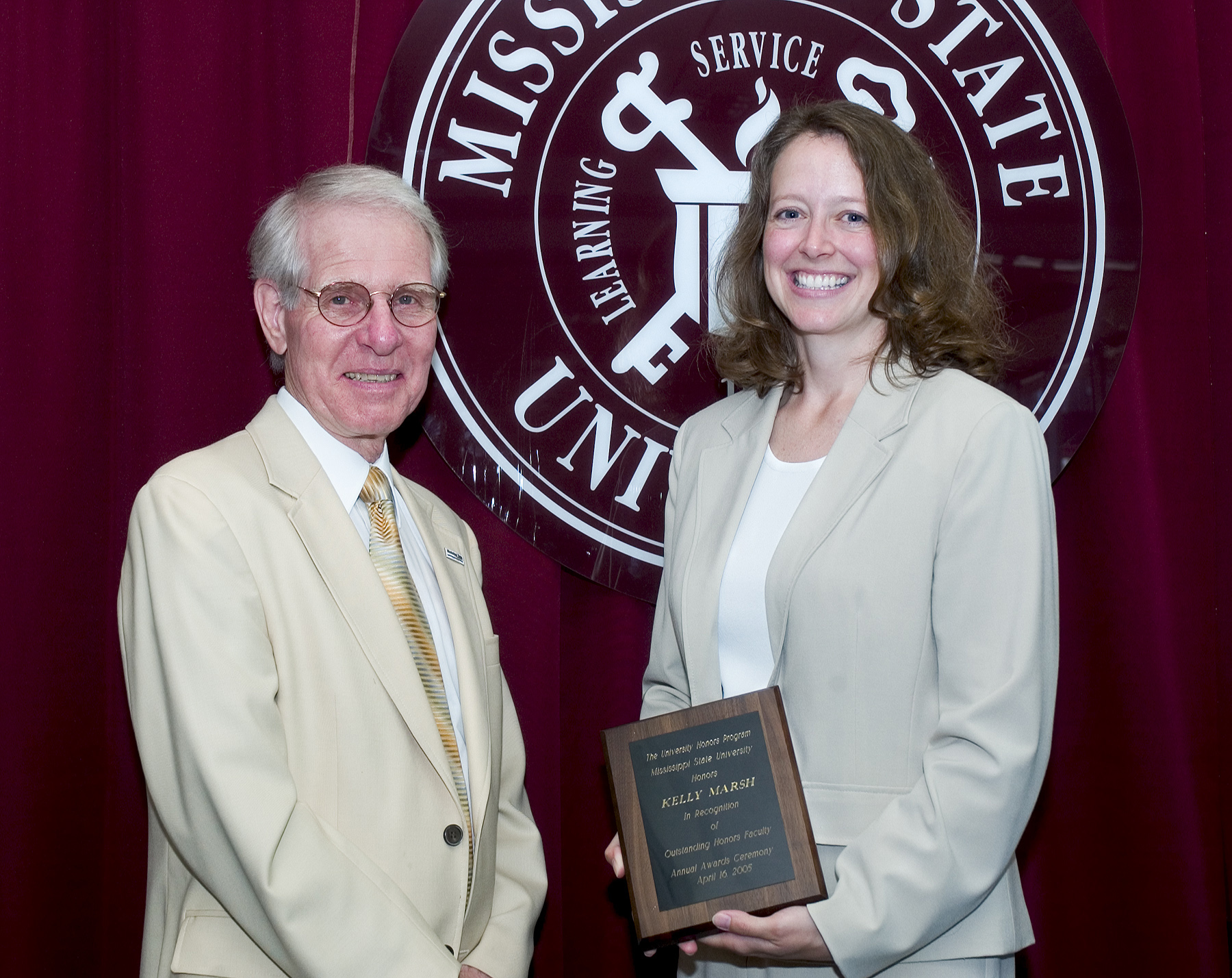 Provost Peter Rabideau presents the Outstanding Honors Faculty Award to English department faculty member Kelly Marsh. Provost Peter Rabideau presents the Outstanding Honors Faculty Award to English department faculty member Kelly Marsh.