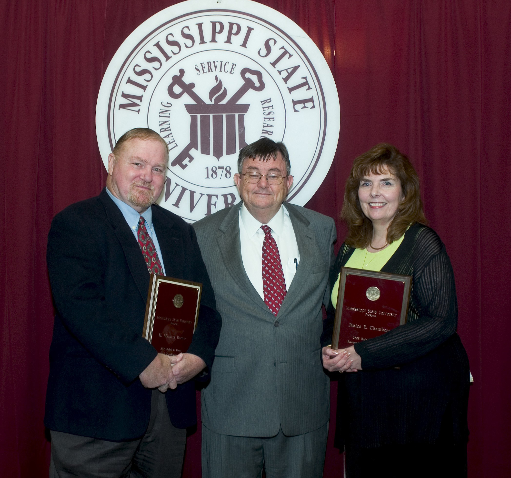 MSU President Charles Lee presented the 2005 Ralph Powe Research Excellence Awards to forestry products professor Michael Barnes and environmental health sciences professor Janice Chambers. MSU President Charles Lee presented the 2005 Ralph Powe Research Excellence Awards to forestry products professor Michael Barnes and environmental health sciences professor Janice Chambers.