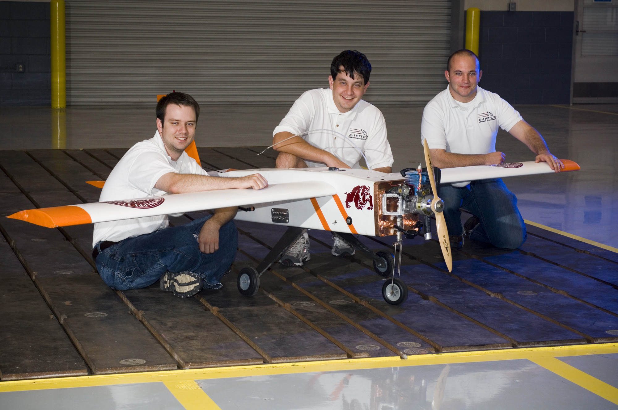 Blake Sanders of Byram,  Nathan Whitfield of Picayune and Ian Broussard of Carencro, La. (l-r),  show off the unmanned aerial vehicle they and 14 other Mississippi State engineering students designed, built and flew in recent international competition.