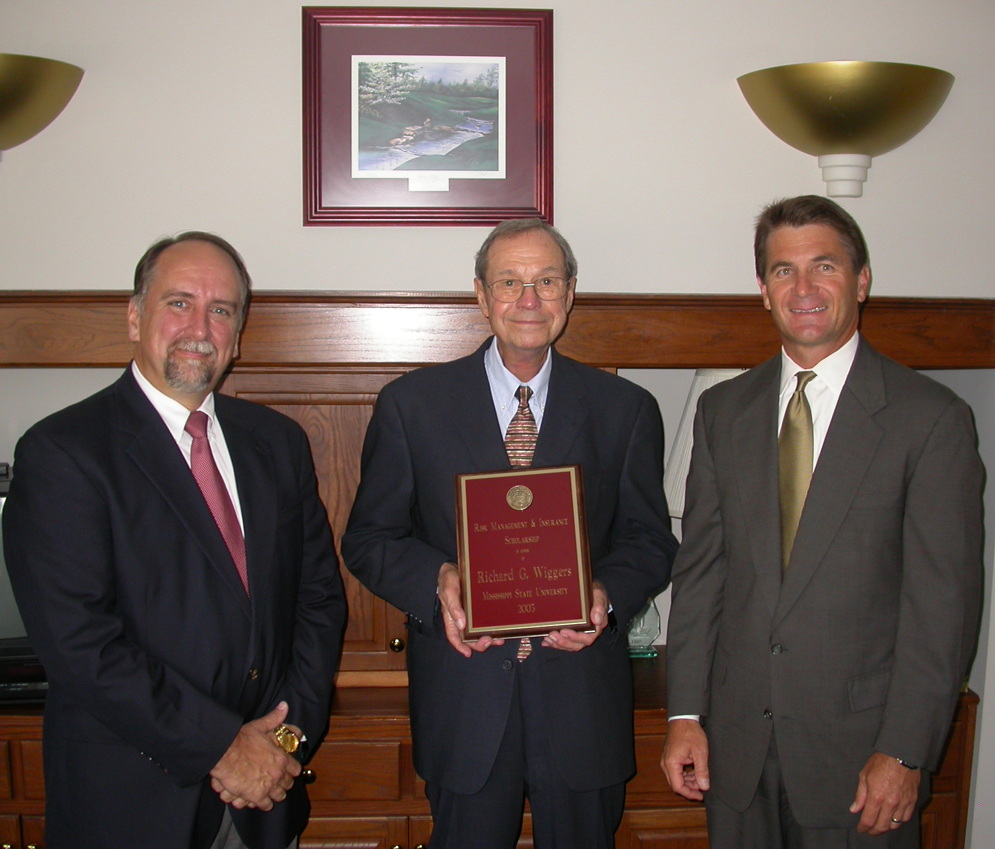 <br /><br />
Dick Wiggers (c) displays a plaque announcing the Wiggers Scholarship at MSU. With him is former business partner James Galloway (r), who endowed the award, and Edwin Duett, holder of the university's Lutken Chair of Insurance. <br /><br />
Dick Wiggers (c) displays a plaque announcing the Wiggers Scholarship at MSU. With him is former business partner James Galloway (r), who endowed the award, and Edwin Duett, holder of the university's Lutken Chair of Insurance.